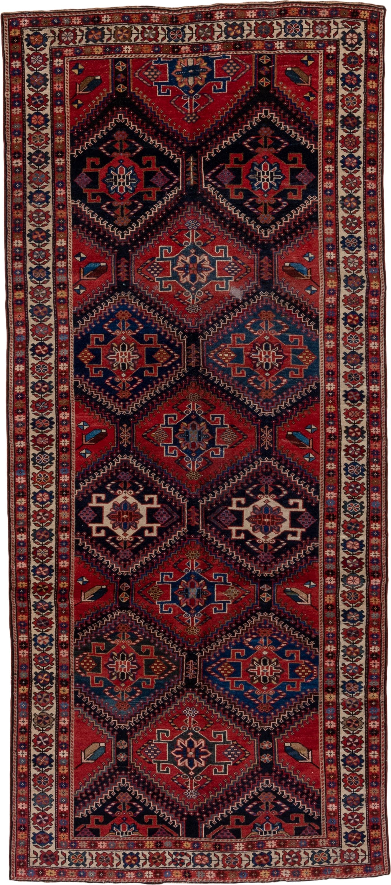 4' x 9' one-of-a-kind handmade antique Baktiary runner rug. Color palette: crimson, navy, ivory, camel, sky blue, rose