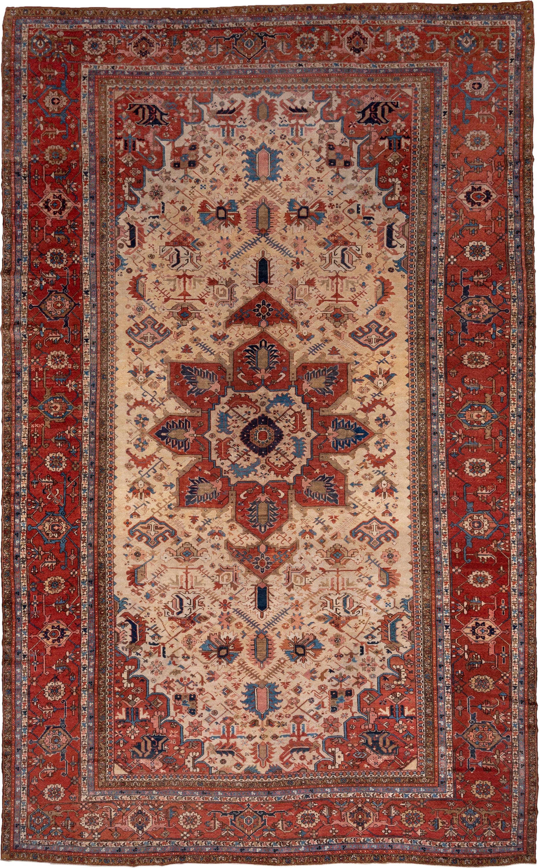 12' x 18' one-of-a-kind handmade antique Serapi oversize rug. Color palette: ivory, rust, brick red, indigo, sky blue, camel