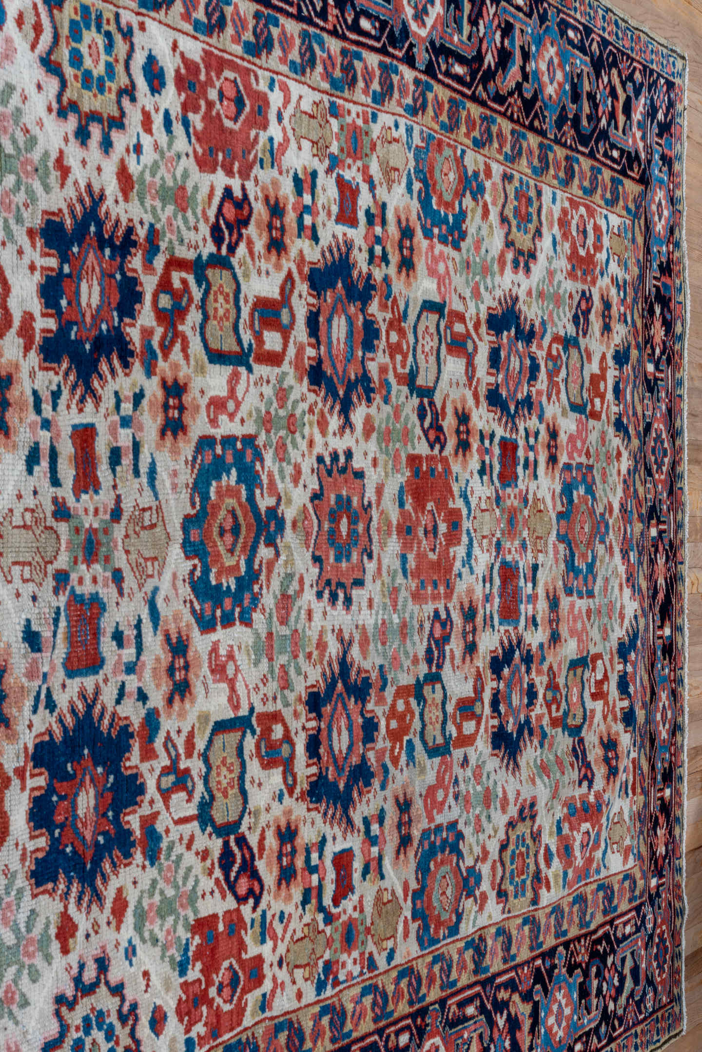7' x 10' one-of-a-kind handmade antique Heriz large size rug. Color palette: ivory, navy, sky blue, rust, blush, crimson