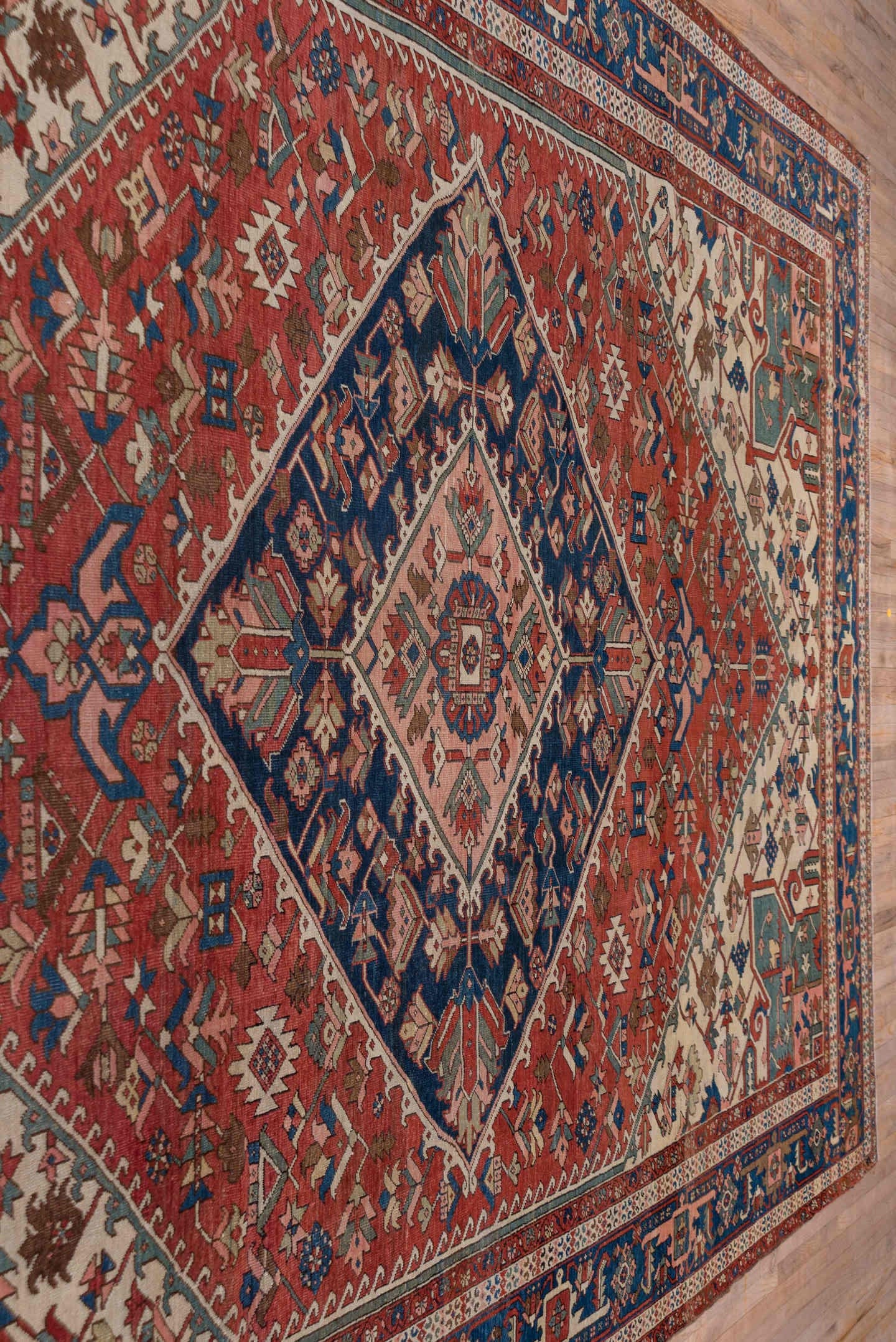 10' x 14' one-of-a-kind handmade antique Serapi large size rug. Color palette: rust, ivory, indigo, sky blue, rose, taupe