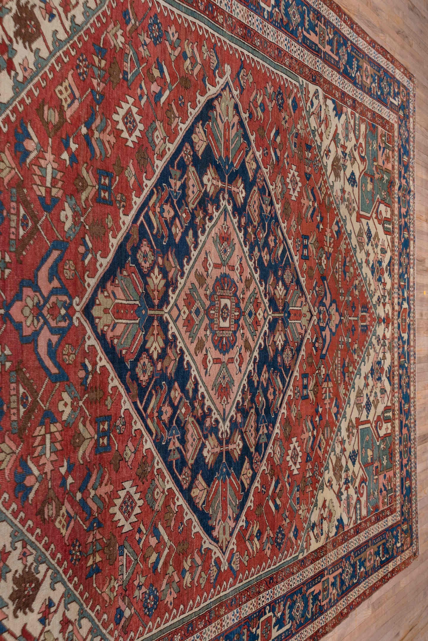 10' x 14' one-of-a-kind handmade antique Serapi large size rug. Color palette: rust, ivory, indigo, sky blue, rose, taupe