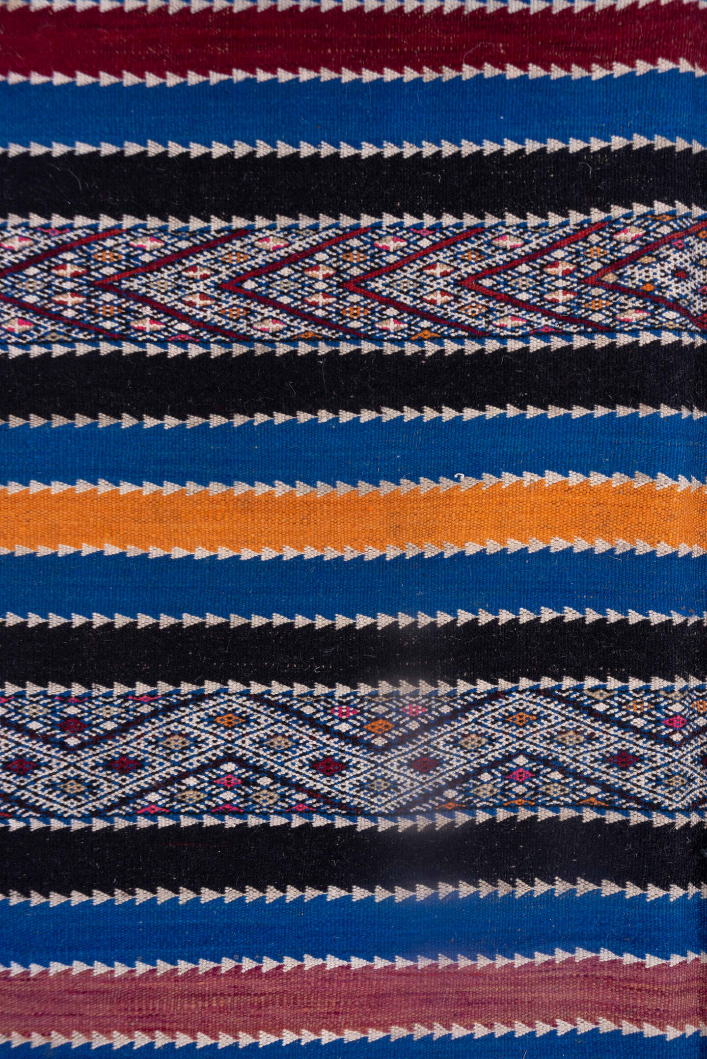5' x 11' one-of-a-kind handmade vintage Kilim rug. Color palette: indigo, ivory, charcoal, rust, burgundy, blue, purple