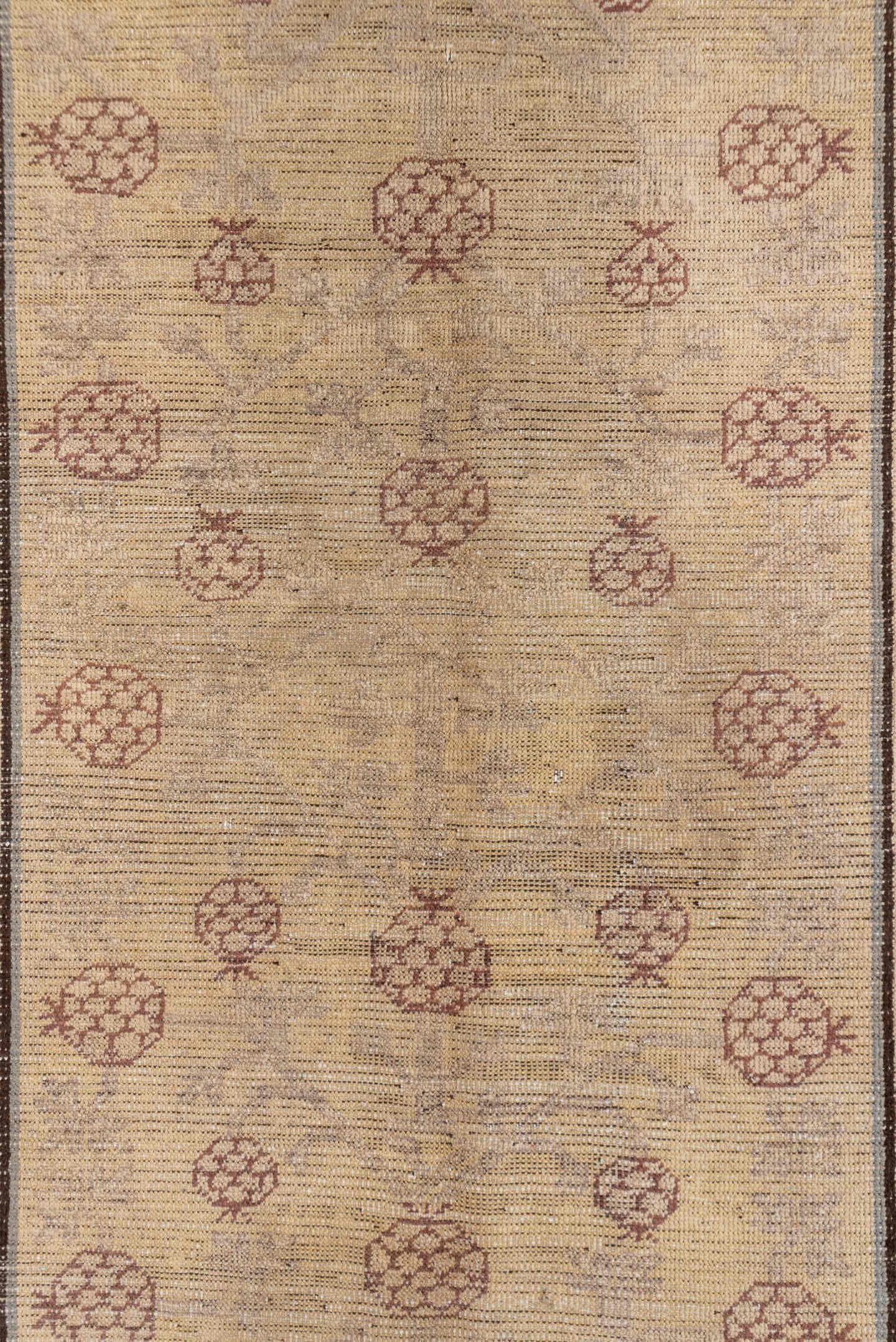 4' x 8' one-of-a-kind handmade vintage Khotan rug. Color palette: ivory, taupe, brown, camel, rose, slate, beige, gray, pink