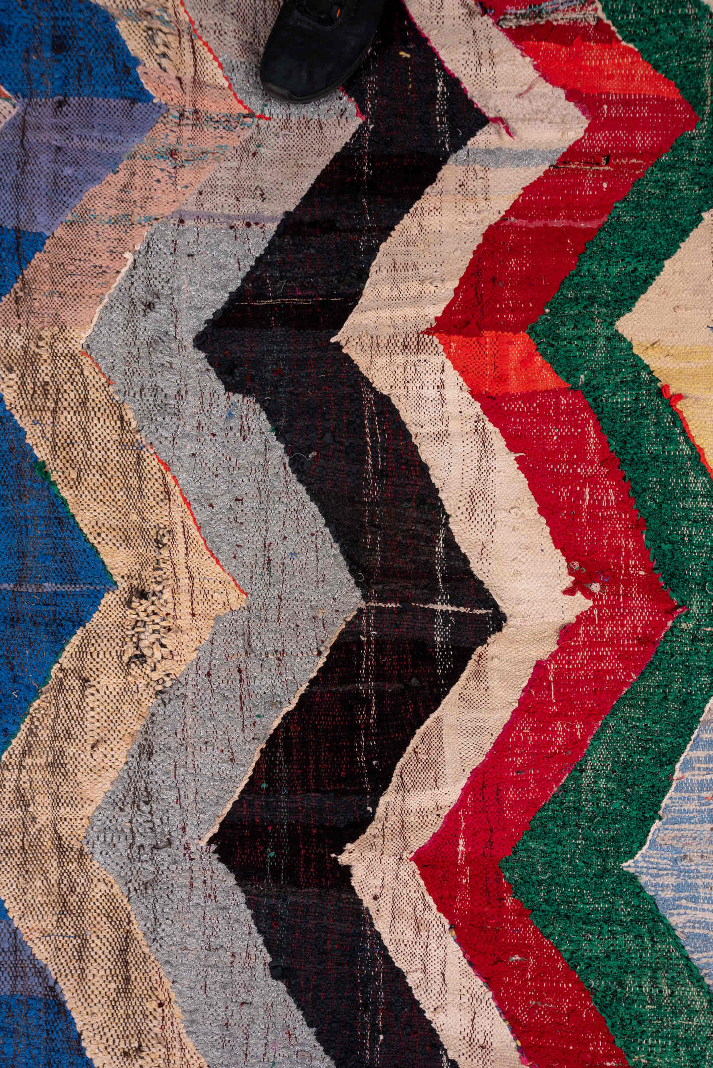 4' x 6' one-of-a-kind handmade vintage Rag Rug small size rug. Color palette: ivory, blue, charcoal, sky_blue, green, red