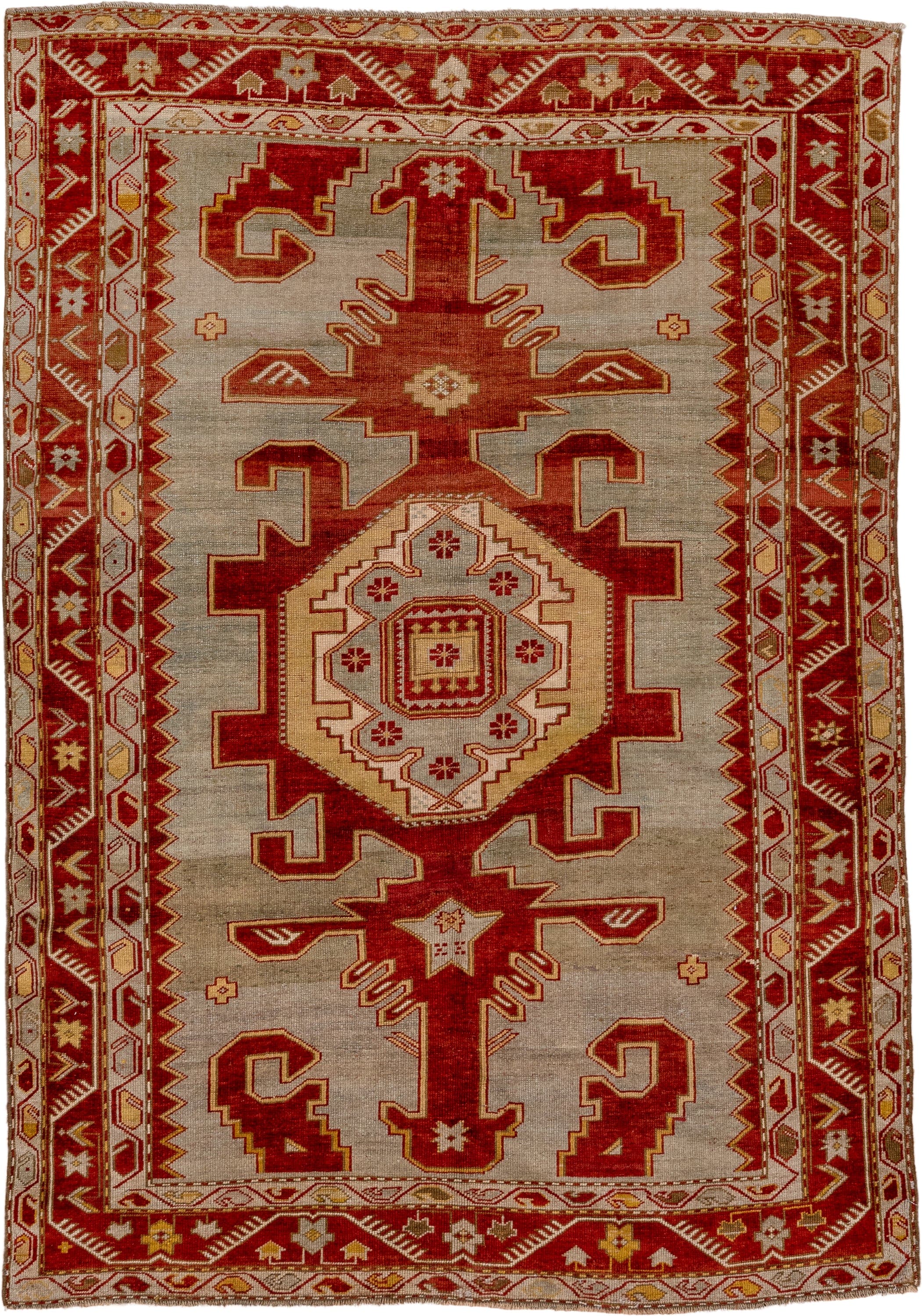 4' x 6' one-of-a-kind handmade antique Caucasian rug. Color palette: ivory, rust, crimson, camel, gold, taupe, terracotta