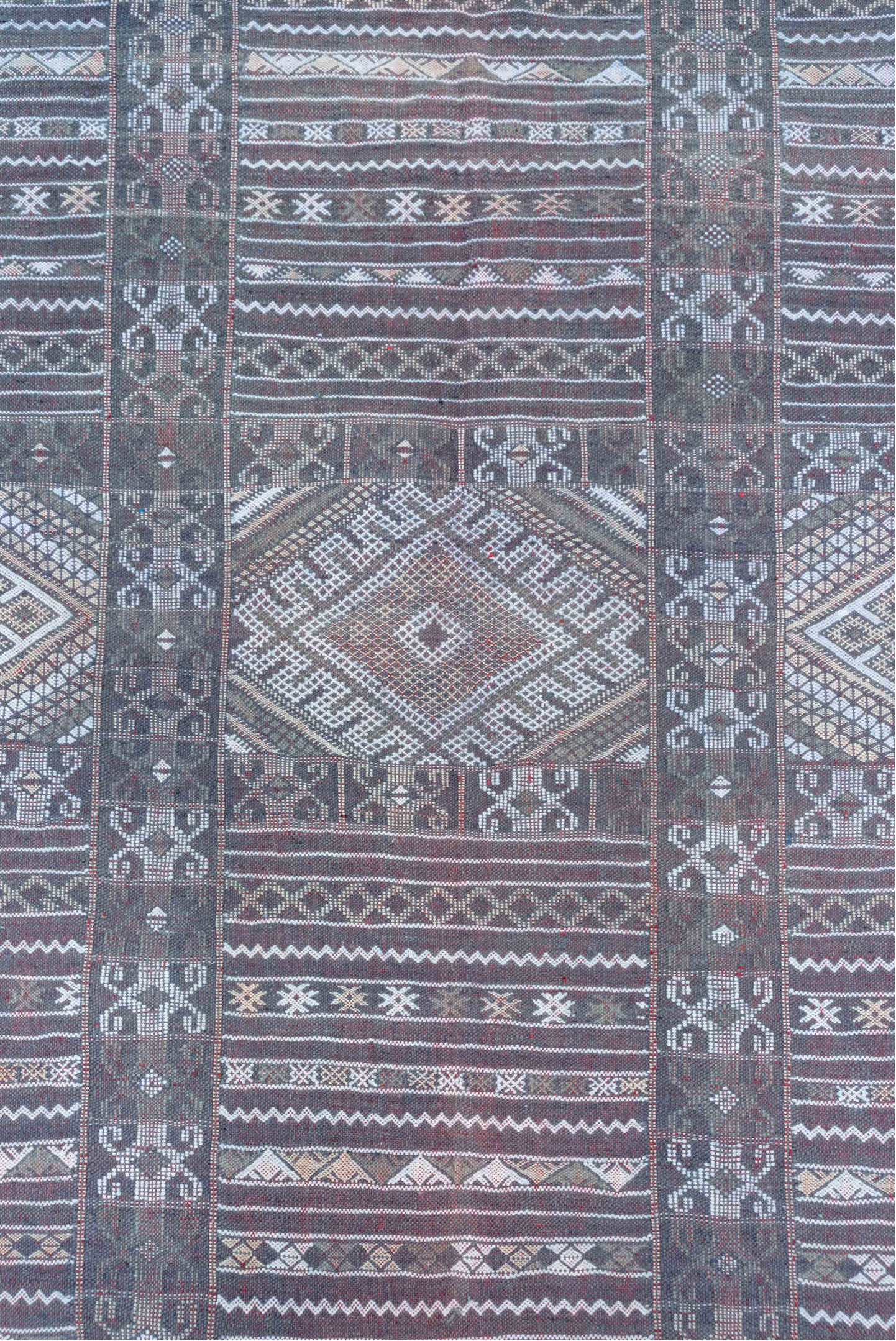 6' x 9' one-of-a-kind handmade vintage Jijim medium size rug. Color palette: taupe, brown, ivory, burgundy, rose, charcoal