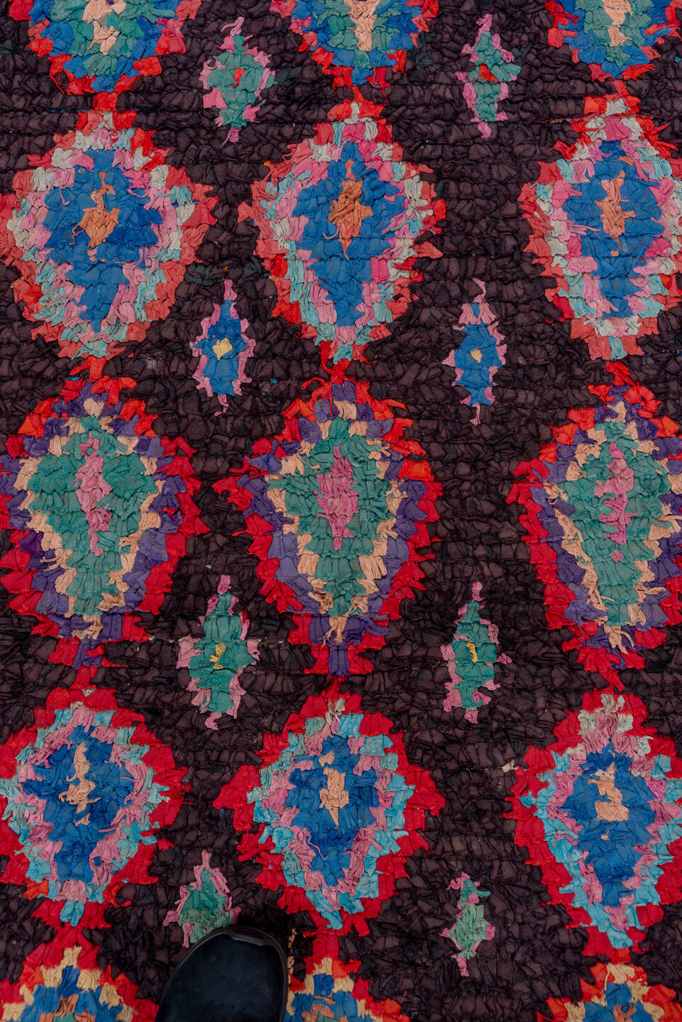 3' x 10' one-of-a-kind handmade vintage Rag Rug runner rug. Color palette: charcoal, crimson, turquoise, lavender, coral