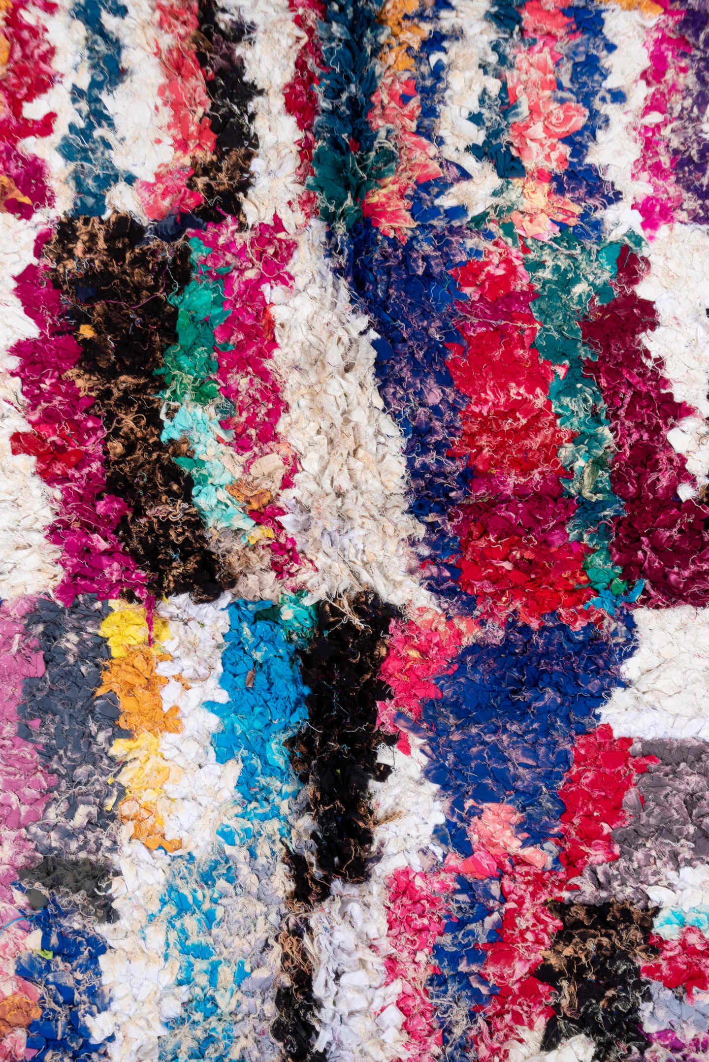 4' x 8' one-of-a-kind handmade vintage Rag Rug rug. Color palette: ivory, magenta, turquoise, cobalt, black, rose, lavender