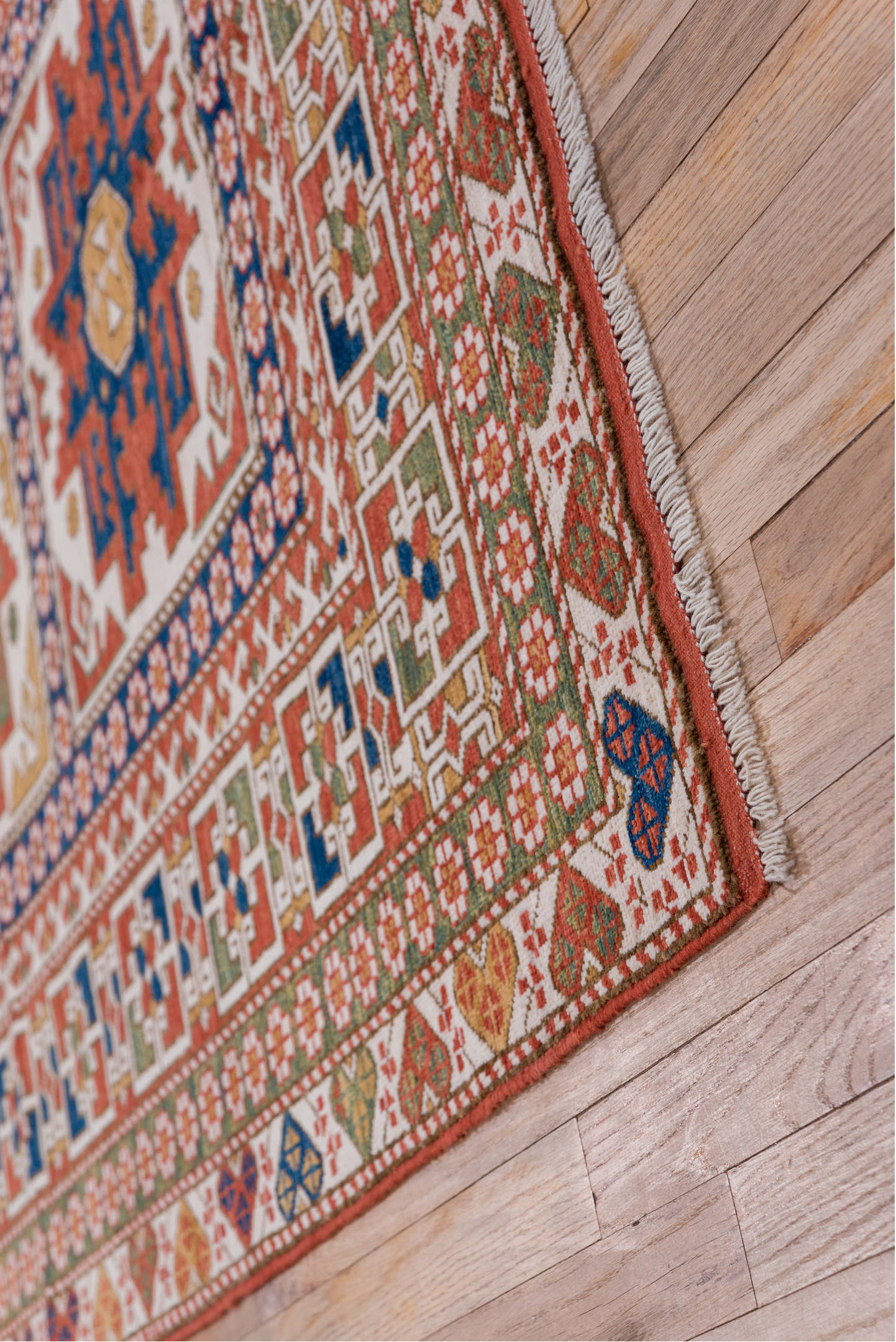 4' x 7' one-of-a-kind handmade vintage Kazak rug. Color palette: ivory, rust, indigo, olive, gold, terra cotta, terracotta