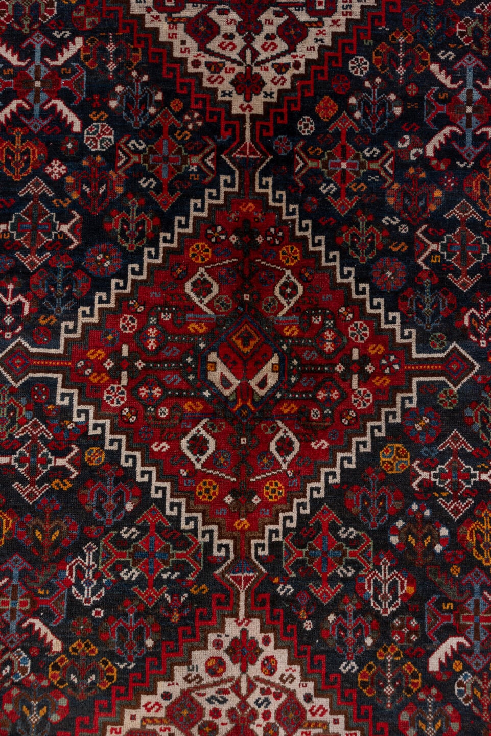 5' x 8' one-of-a-kind handmade antique Shiraz medium size rug. Color palette: red, navy, ivory, rust, burgundy, slate, gold