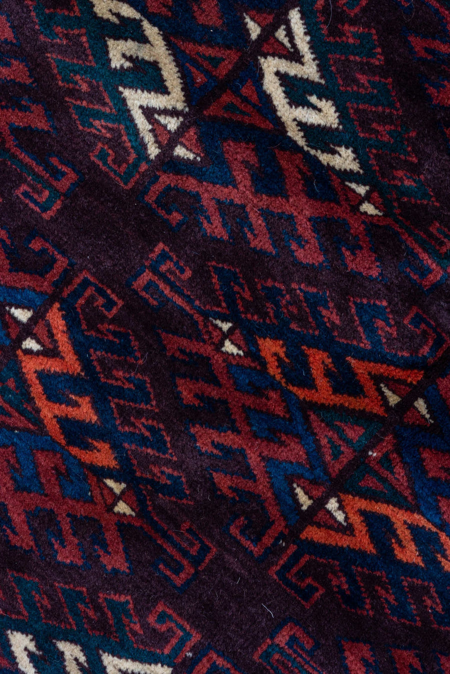6' x 10' one-of-a-kind handmade vintage Yamoud large size rug. Color palette: burgundy, navy, rust, ivory, crimson, indigo