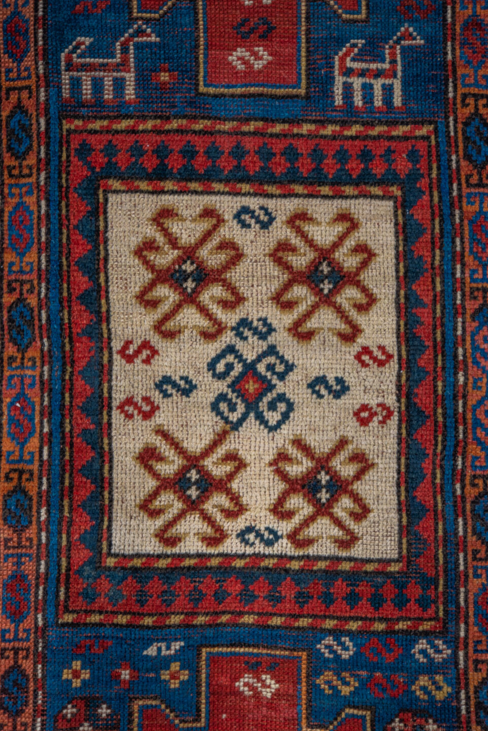 3' x 6' one-of-a-kind handmade antique Kazak runner rug. Color palette: blue, ivory, red, navy, rust, teal, brown