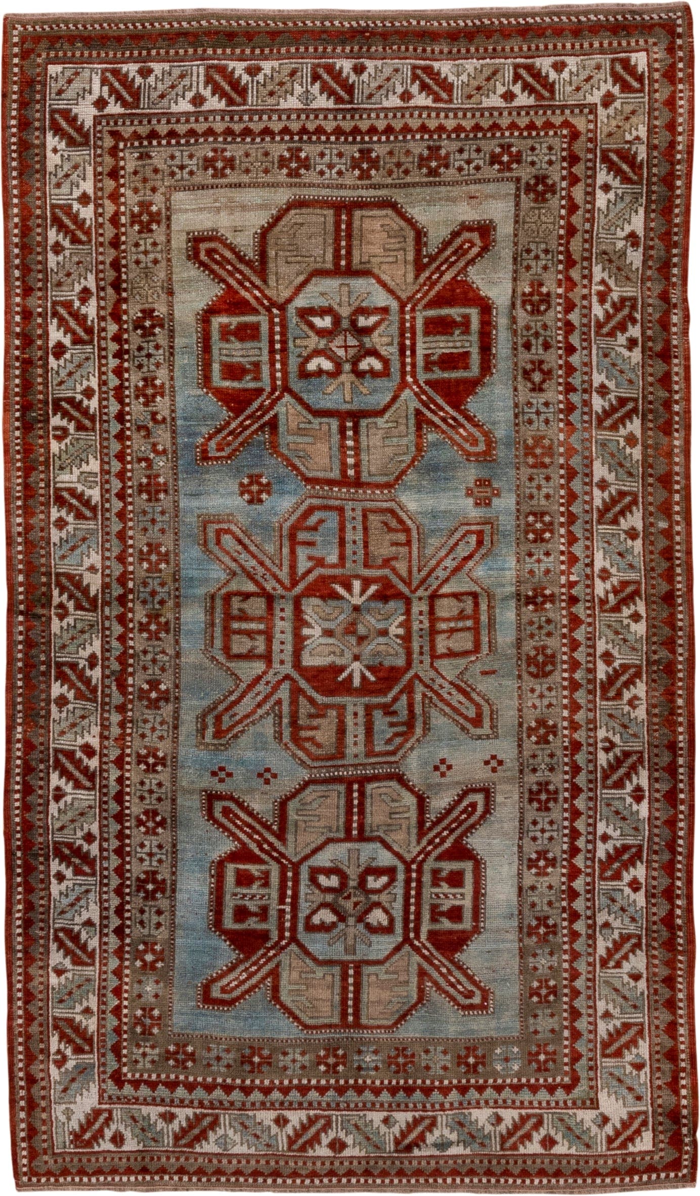 4' x 7' one-of-a-kind handmade antique Kazak rug. Color palette: rust, ivory, sky blue, taupe, brick, camel, terracotta