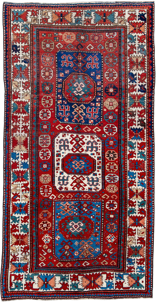 5' x 10' one-of-a-kind handmade antique Kazak medium size rug. Color palette: red, ivory, blue, teal, navy, rust, cream