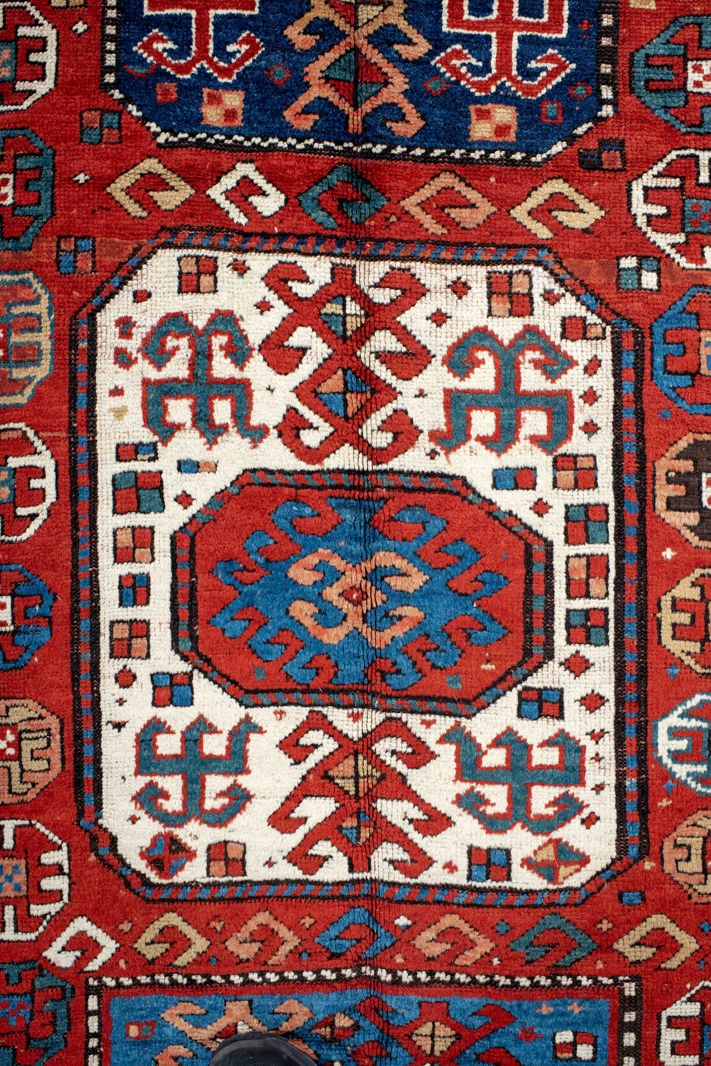 5' x 10' one-of-a-kind handmade antique Kazak medium size rug. Color palette: red, ivory, blue, teal, navy, rust, cream