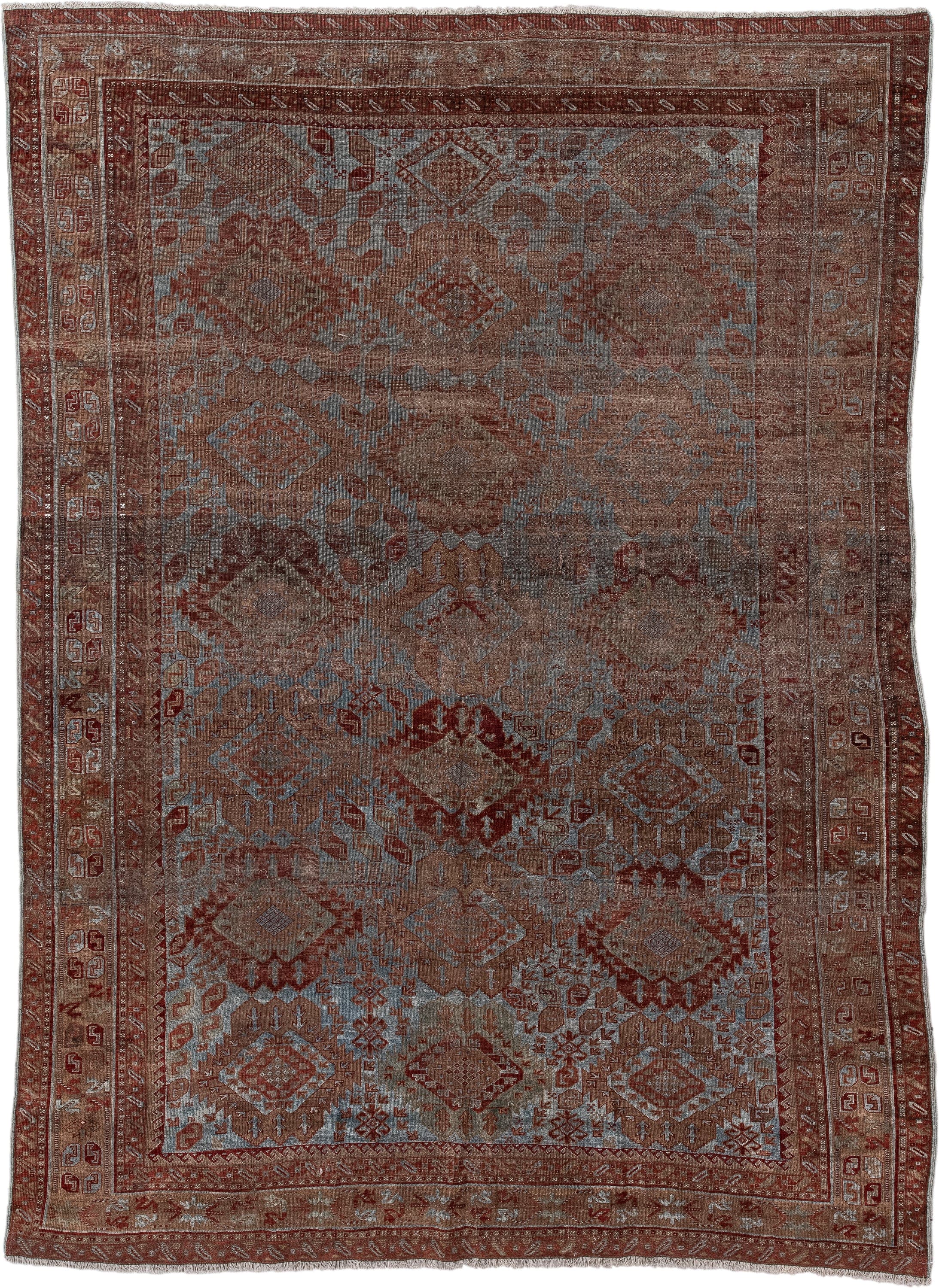 6' x 9' one-of-a-kind handmade antique Belouch rug. Color palette: rust, dusty blue, ivory, taupe, burgundy, brown