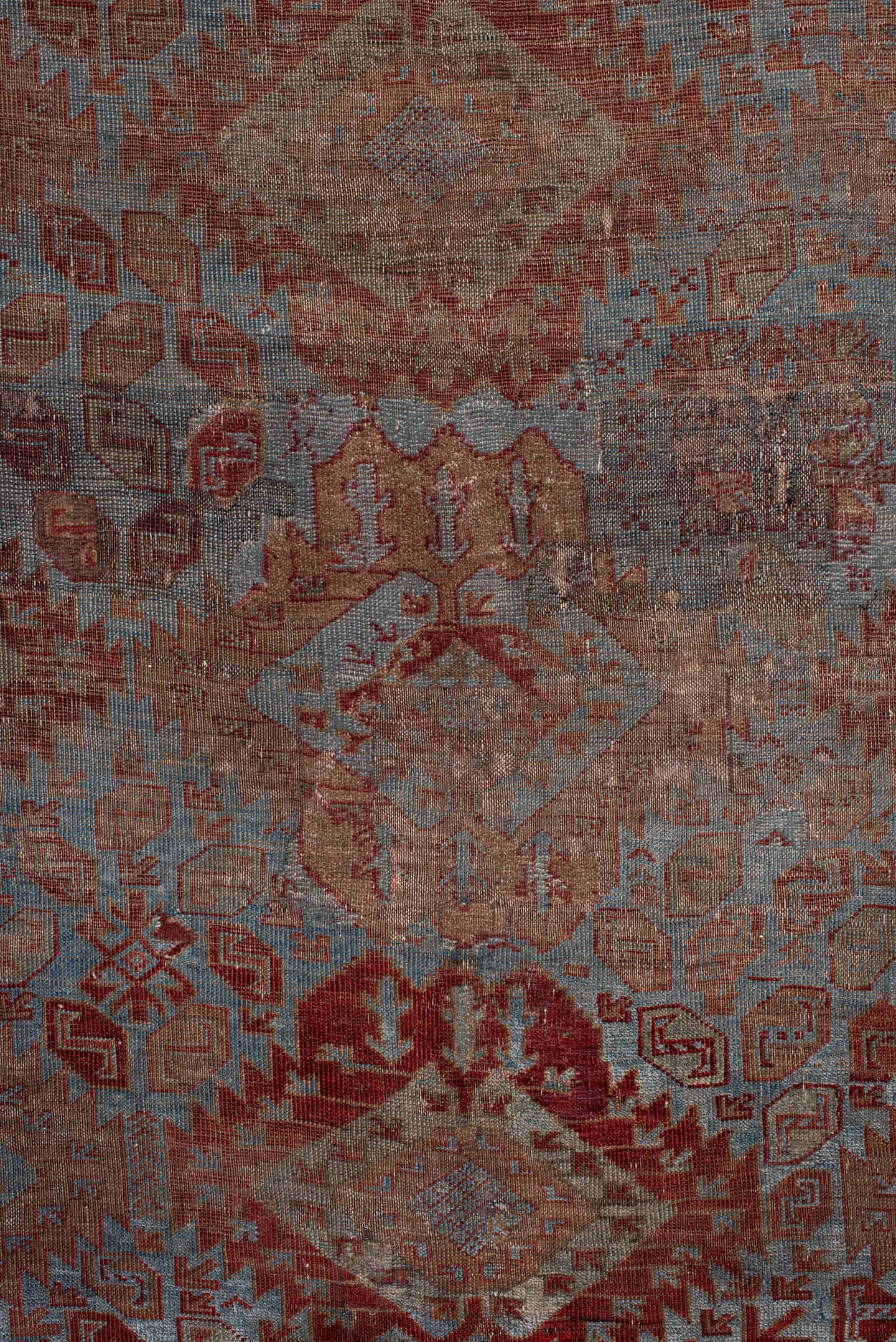 6' x 9' one-of-a-kind handmade antique Belouch rug. Color palette: rust, dusty blue, ivory, taupe, burgundy, brown