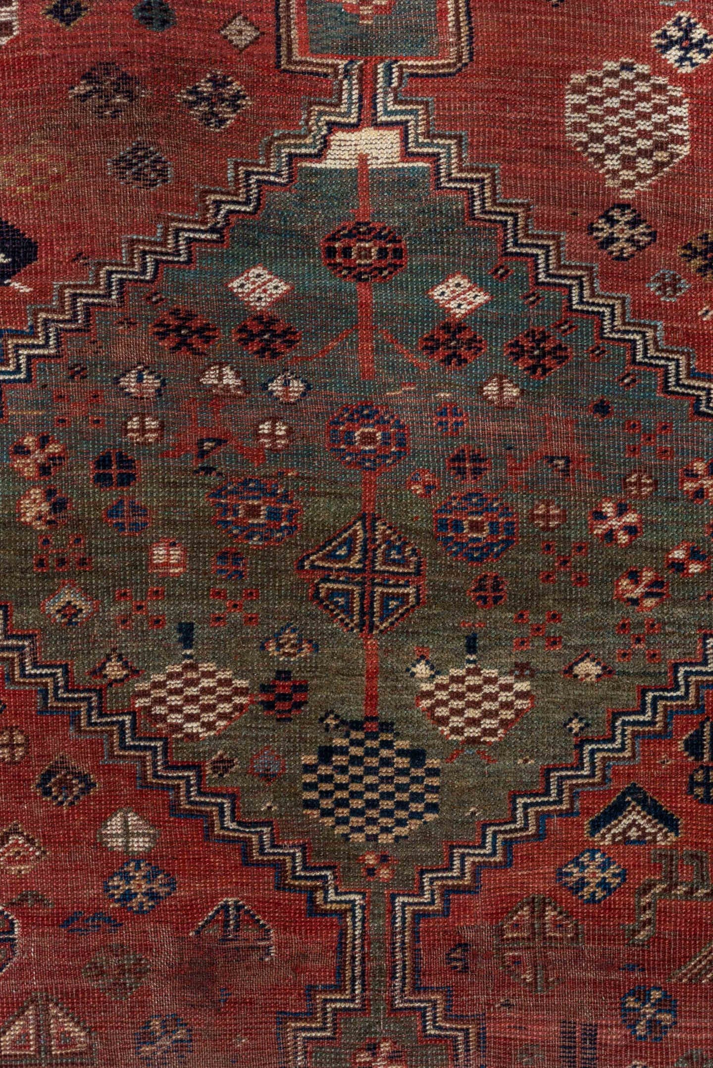 5' x 8' one-of-a-kind handmade antique Qashqai medium size rug. Color palette: rust, indigo, ivory, slate, terra cotta