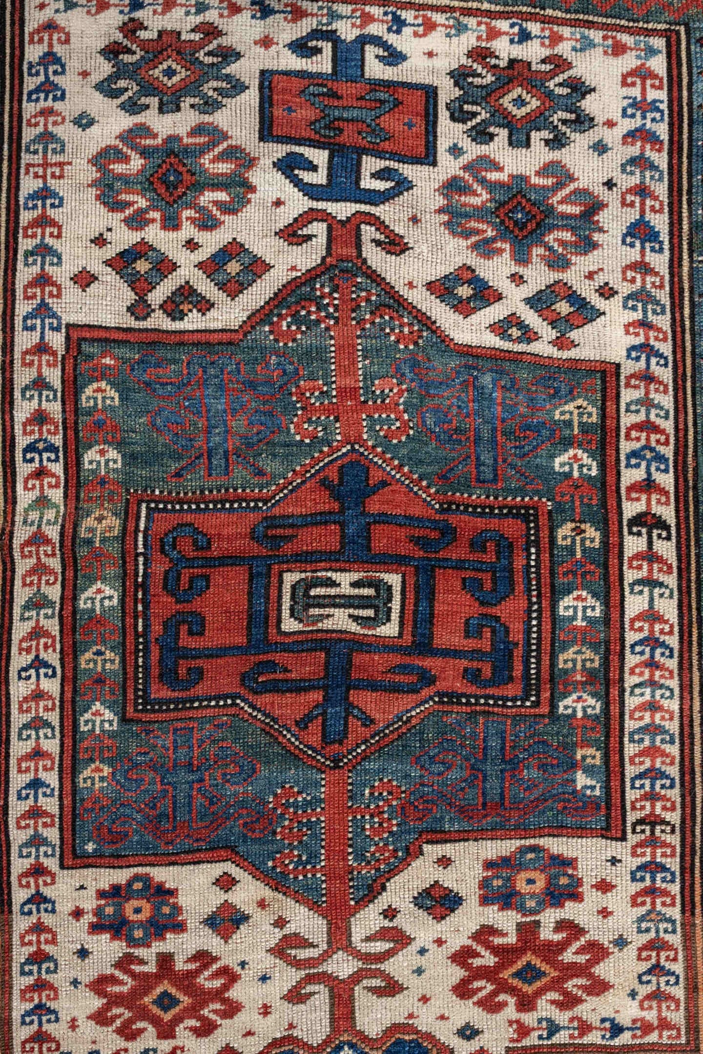 3' x 5' one-of-a-kind handmade antique Kazak small size rug. Color palette: terracotta, ivory, indigo, rust, sky_blue, navy