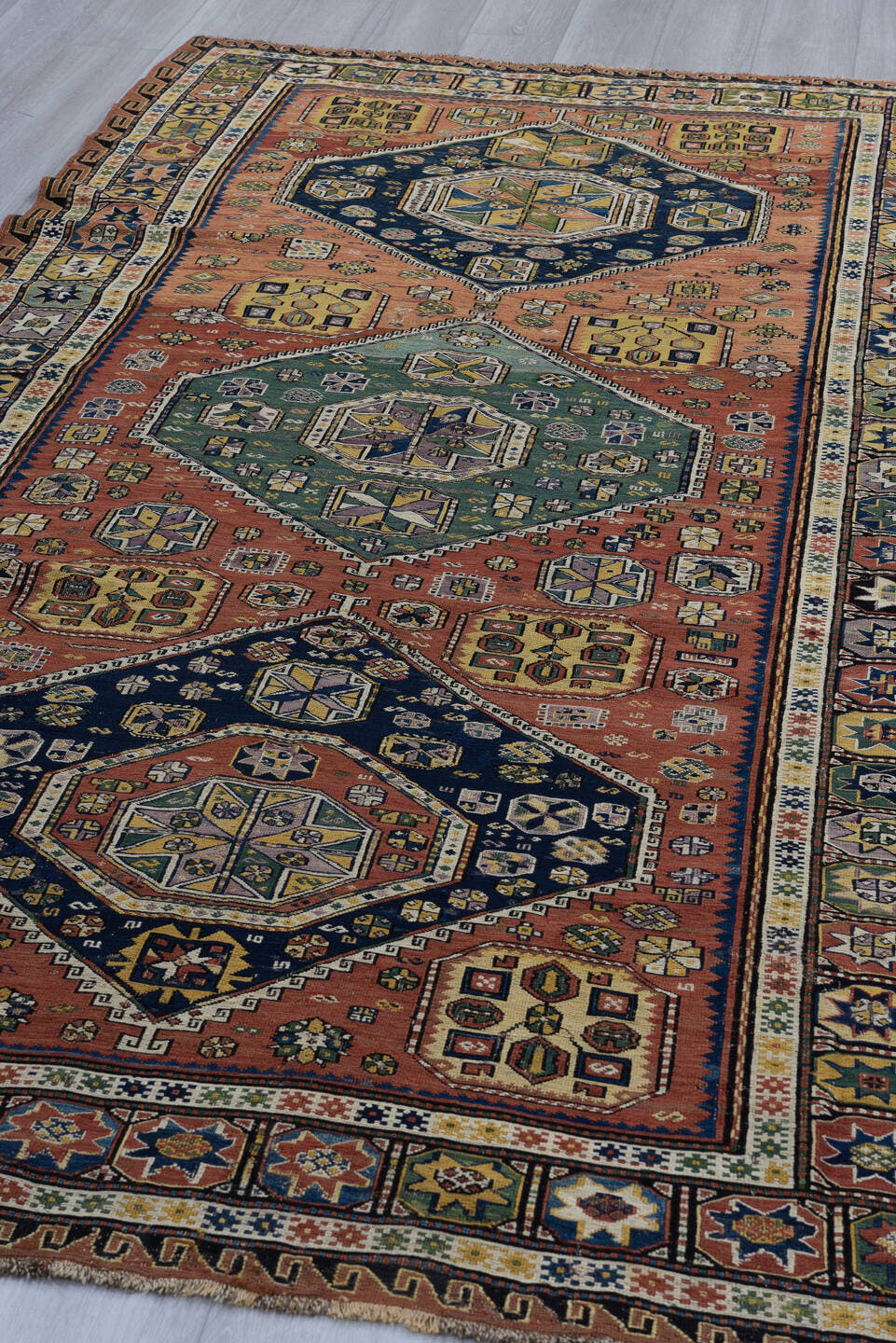 5' x 9' one-of-a-kind handmade vintage Sumak medium size rug. Color palette: rust, navy, ivory, sage, camel, charcoal
