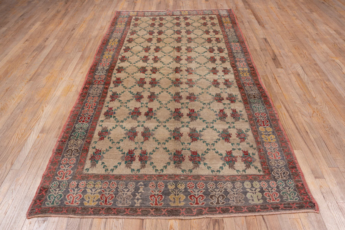 5' x 10' one-of-a-kind handmade vintage Konya rug. Color palette: ivory, charcoal, rust, teal, taupe, gold, crimson, gray