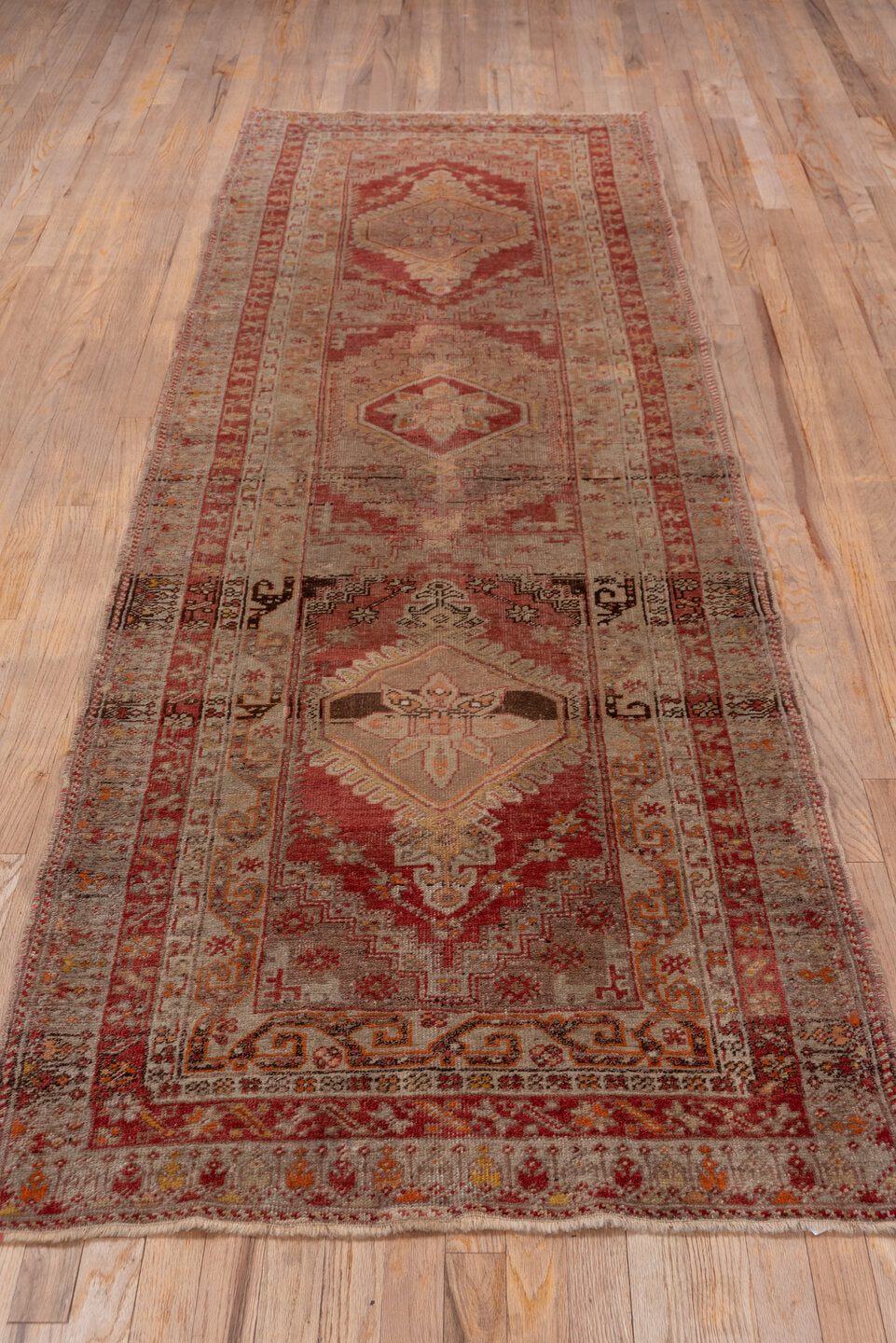 3' x 10' one-of-a-kind handmade vintage Sivas runner rug. Color palette: brown, gray, off-white, pink, red, snow, white