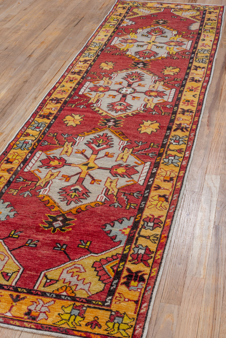 2' x 9' one-of-a-kind handmade vintage Oushak runner rug. Color palette: red, gold, ivory, rust, saffron, charcoal, rose