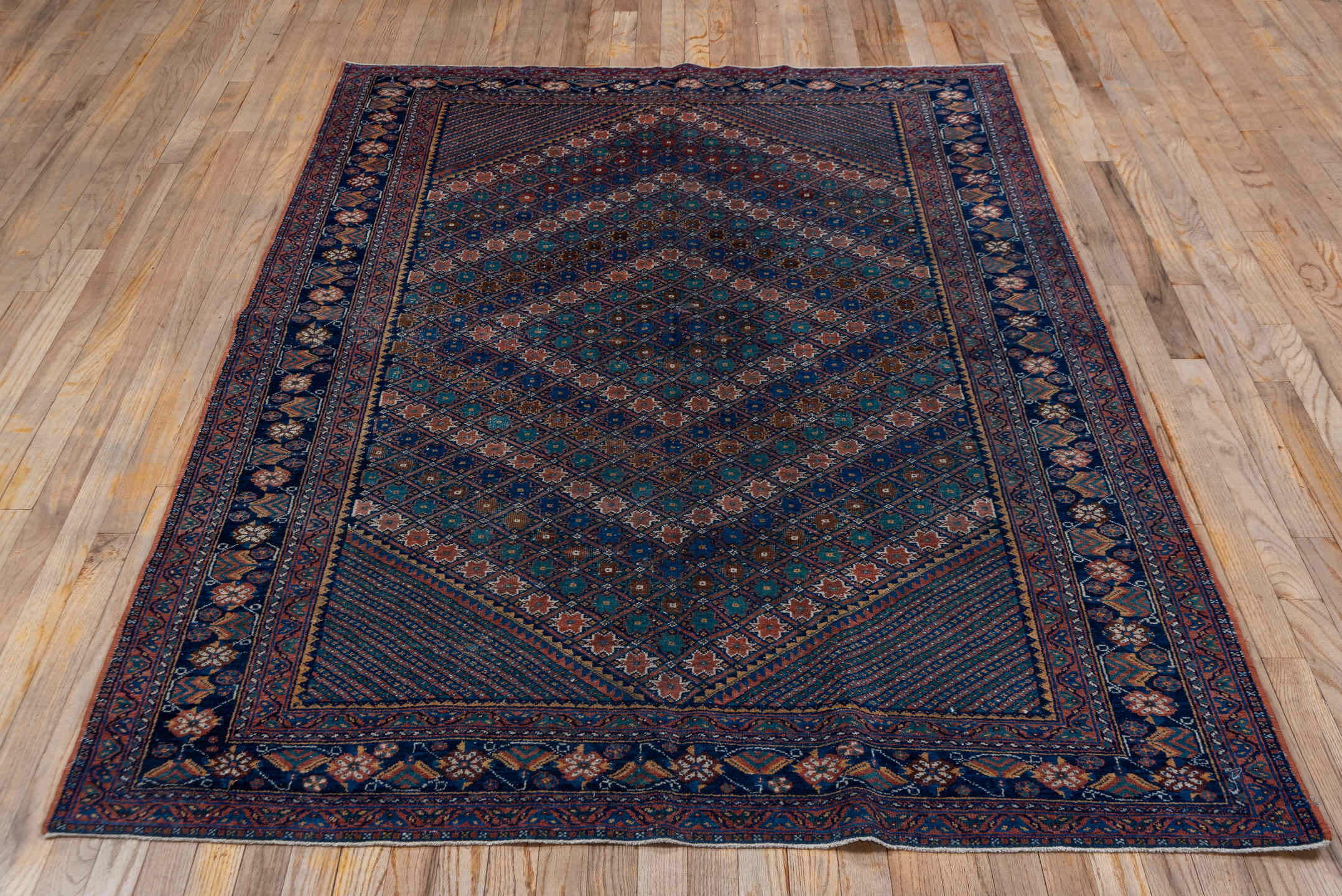 5' x 7' one-of-a-kind handmade antique Afshar rug. Color palette: navy, rust, camel, teal, ivory, rose, brown, blue