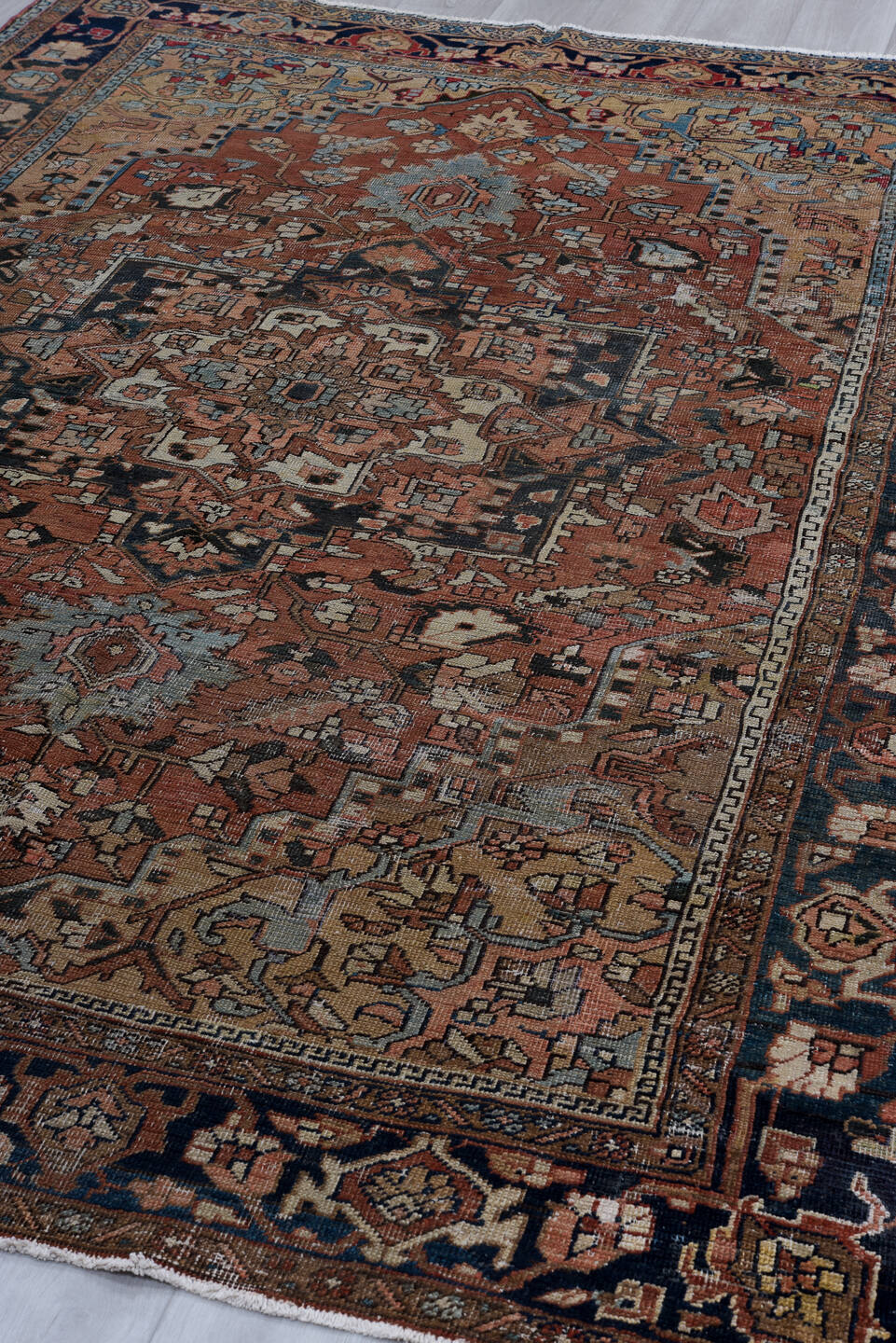 6' x 9' one-of-a-kind handmade antique Heriz medium size rug. Color palette: terra cotta, navy, ivory, slate, taupe, rust