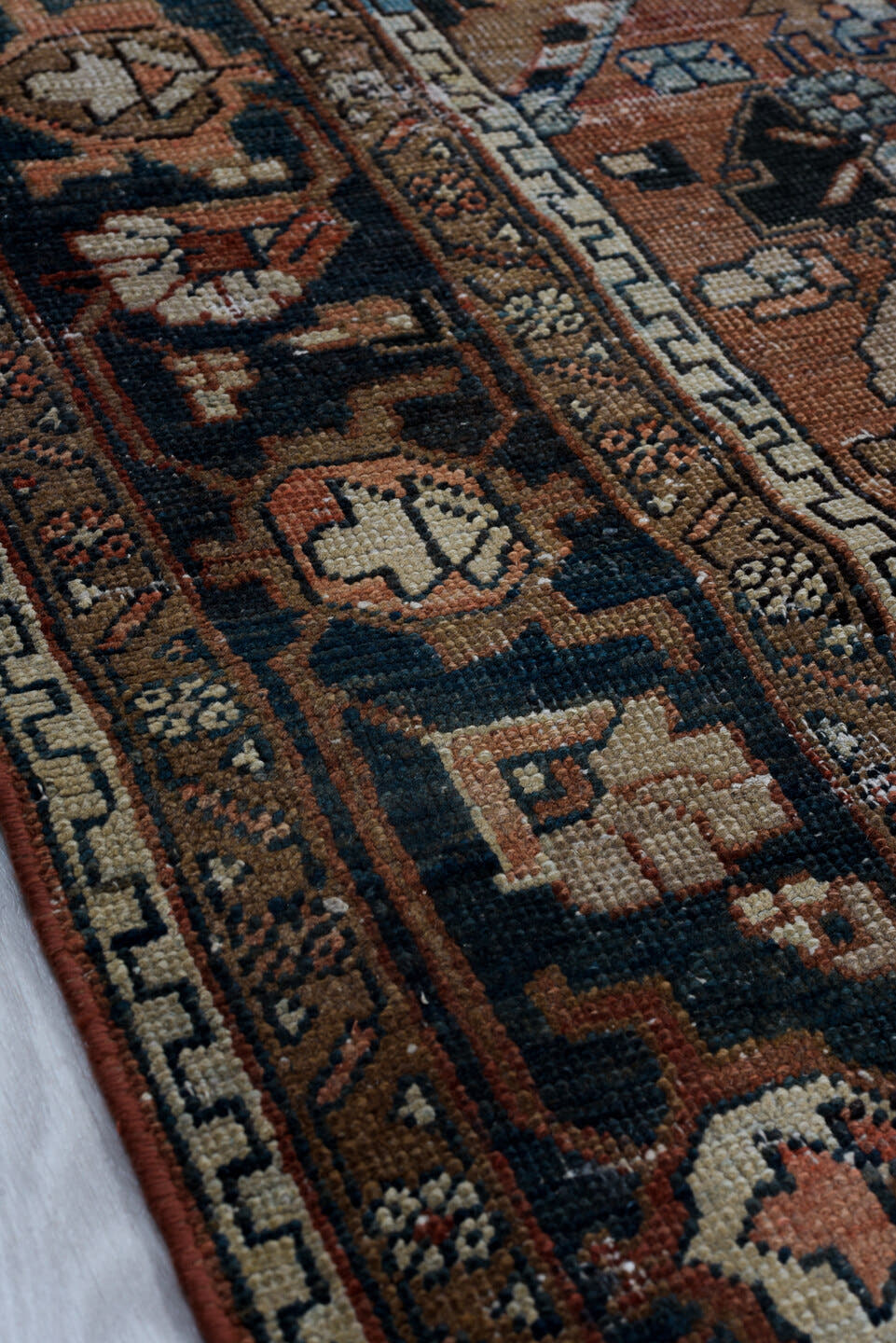 6' x 9' one-of-a-kind handmade antique Heriz medium size rug. Color palette: terra cotta, navy, ivory, slate, taupe, rust