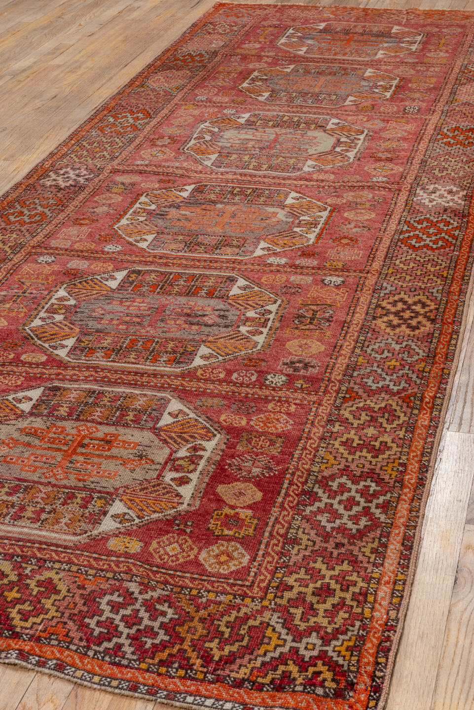 4' x 11' one-of-a-kind handmade vintage Oushak runner rug. Color palette: brown, maroon, pink, red, sienna