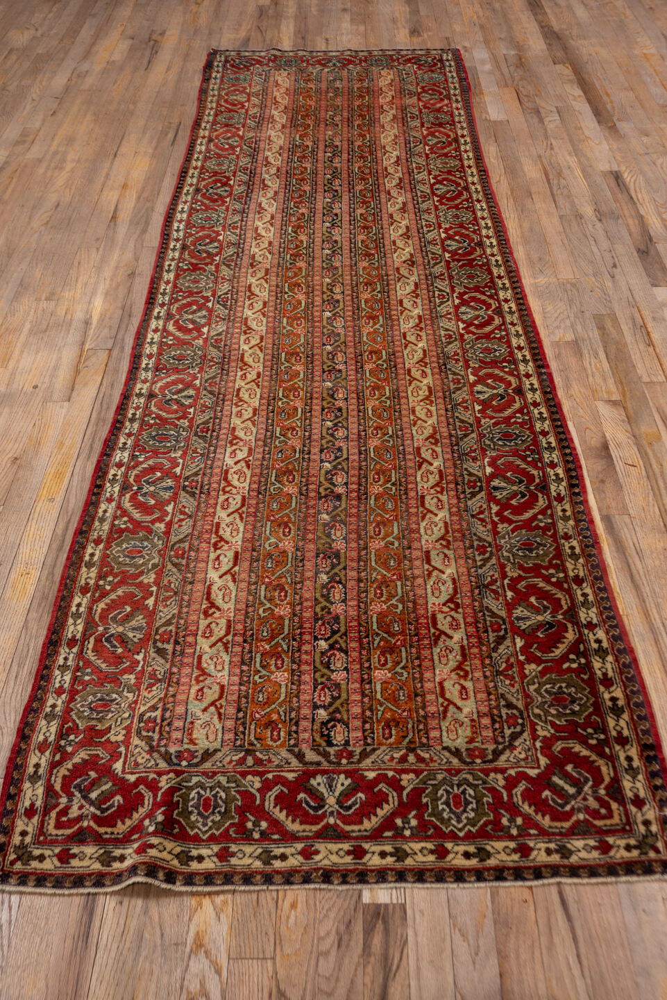 3' x 11' one-of-a-kind handmade vintage Sivas runner rug. Color palette: brown, maroon, orange, pink, red, tan