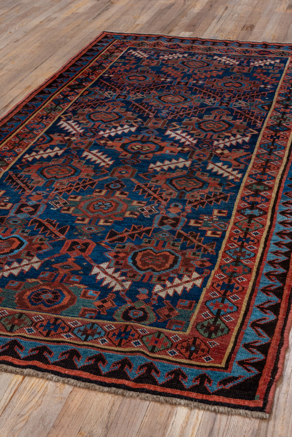 4' x 7' one-of-a-kind handmade antique NW Persian rug. Color palette: indigo, rust, ivory, crimson, slate, camel, charcoal
