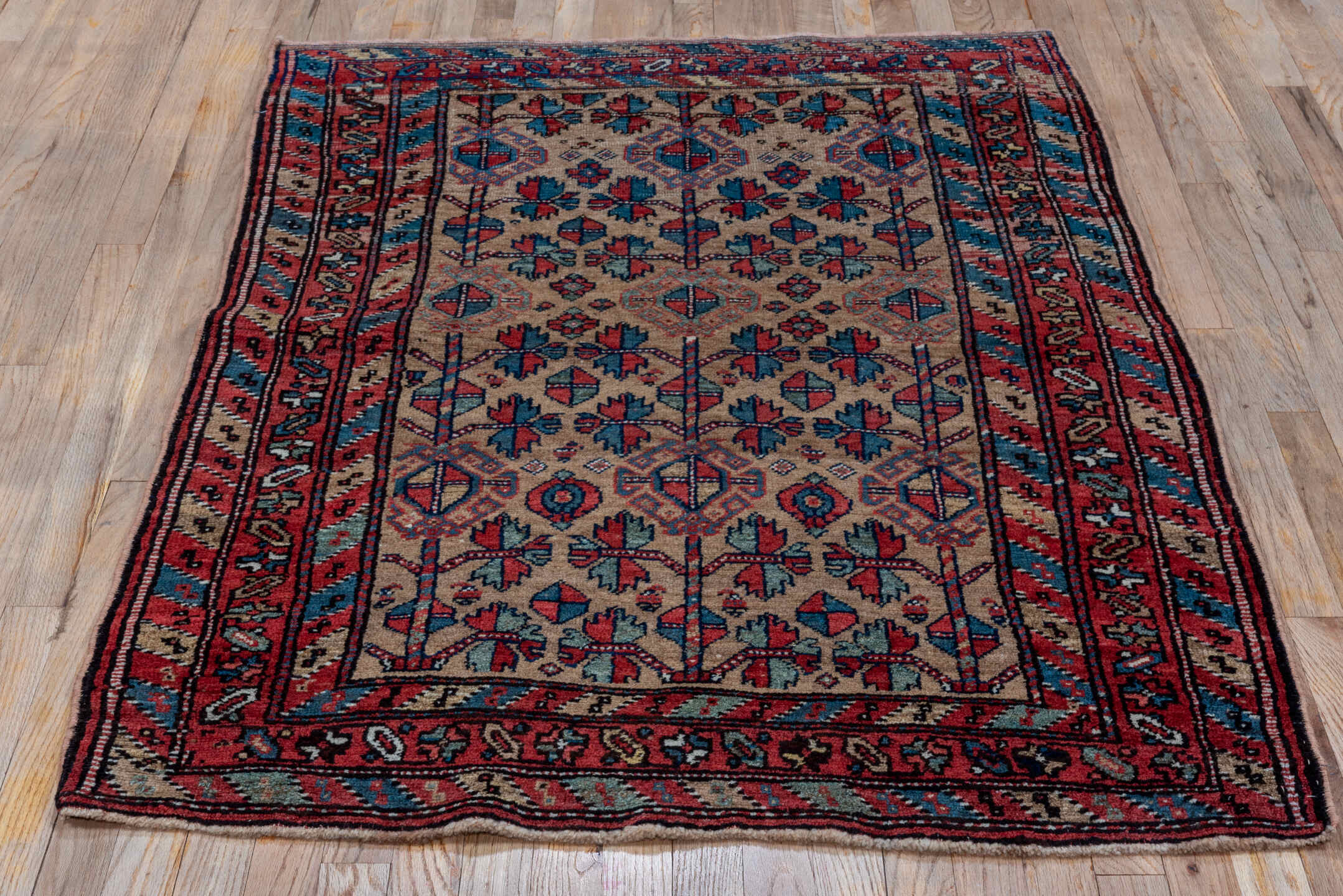 3' x 5' one-of-a-kind handmade vintage Kurd small size rug. Color palette: rust, camel, indigo, ivory, crimson, charcoal