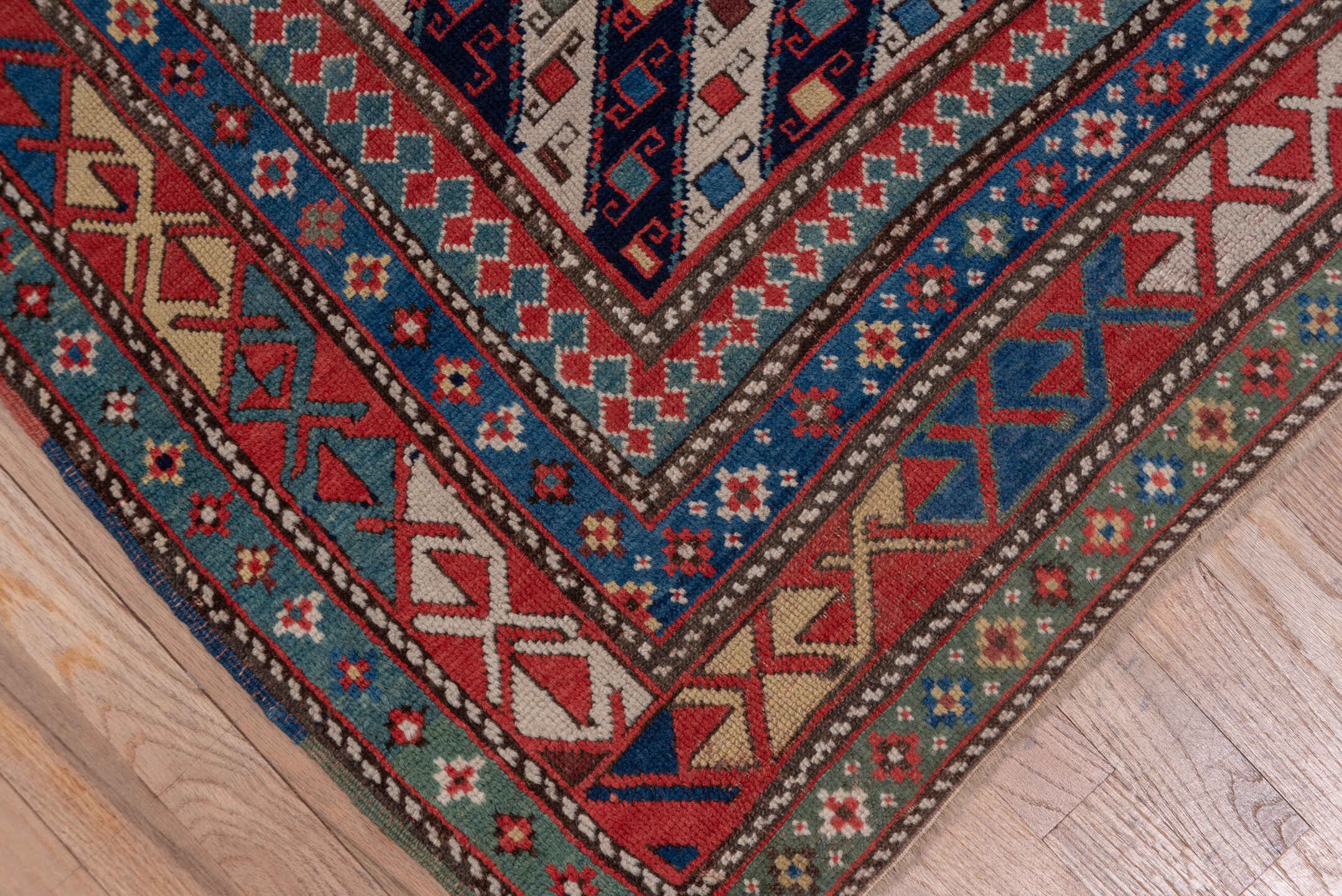 3' x 12' one-of-a-kind handmade vintage Genje runner rug. Color palette: black, blue, brown, gray, pink, red