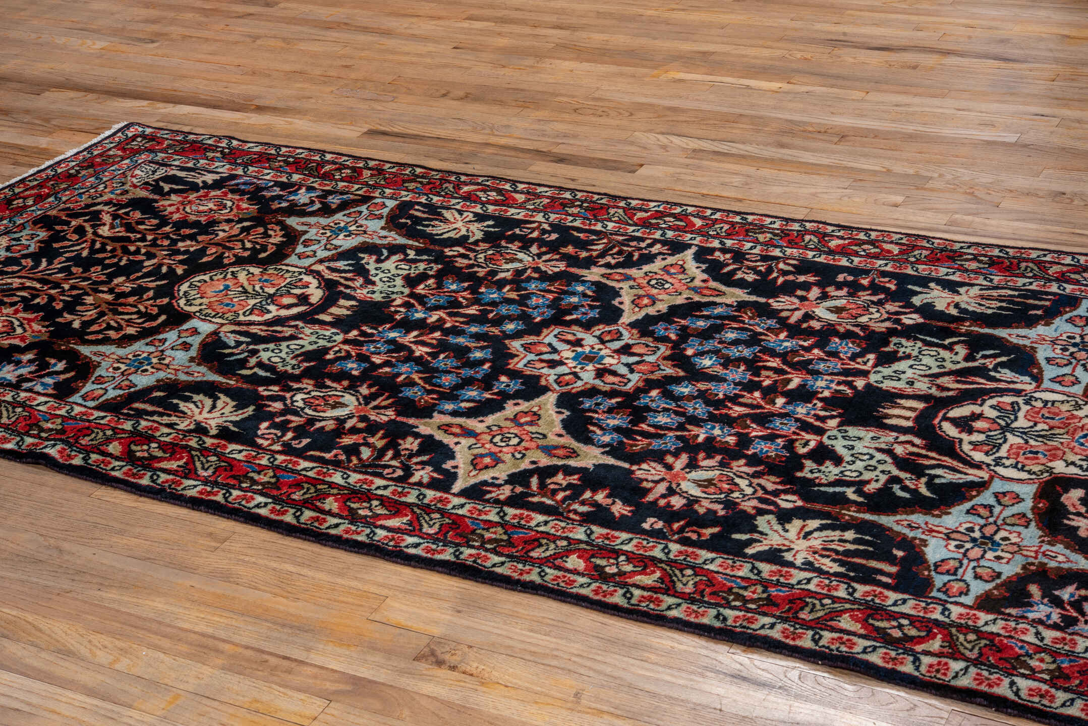 4' x 10' one-of-a-kind handmade vintage Mahal runner rug. Color palette: arapawa, black, blue, brown, gray, pink, red