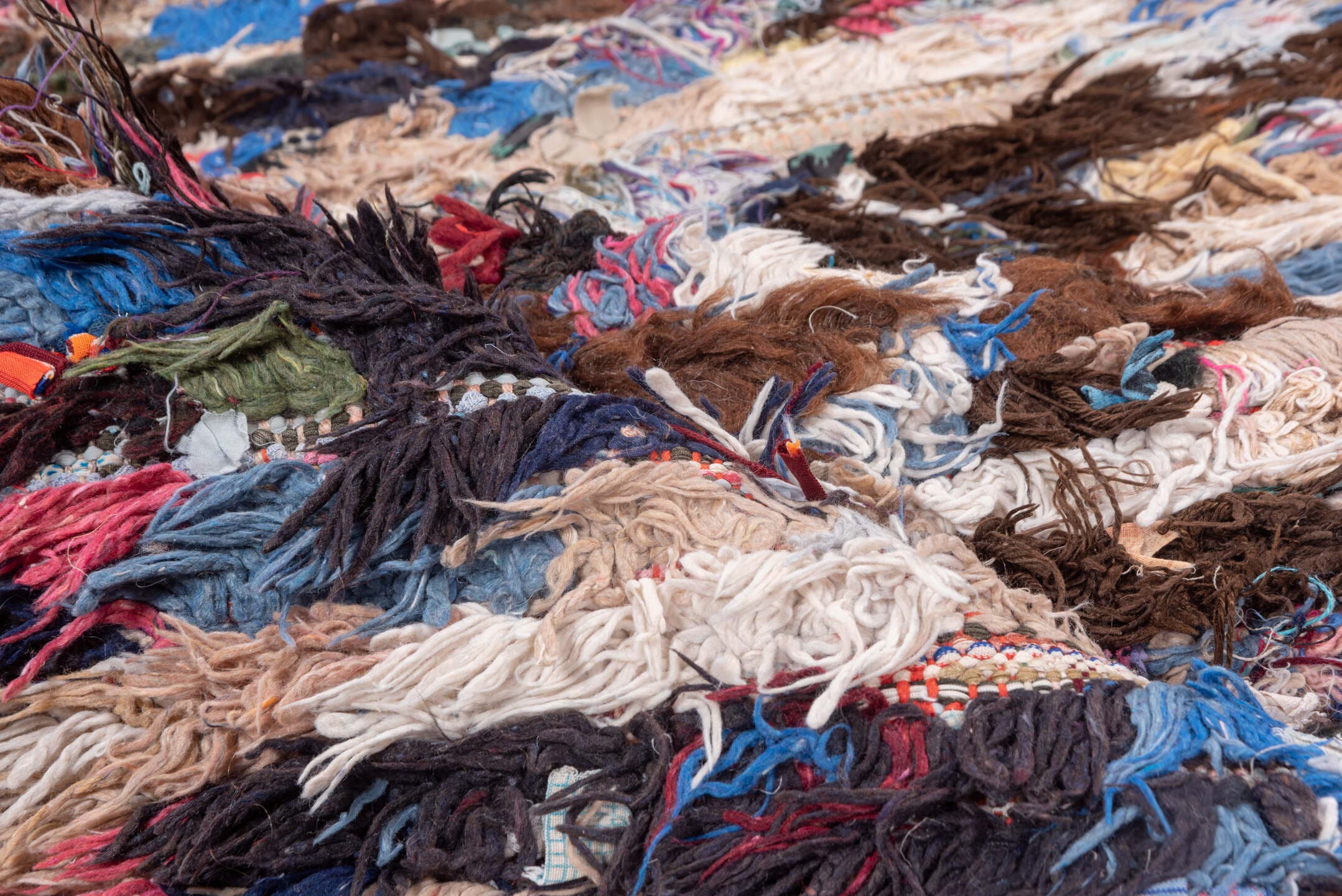 2' x 6' one-of-a-kind handmade vintage Rag Rug runner rug. Color palette: brown, ivory, blue, red, charcoal, cream, burgundy