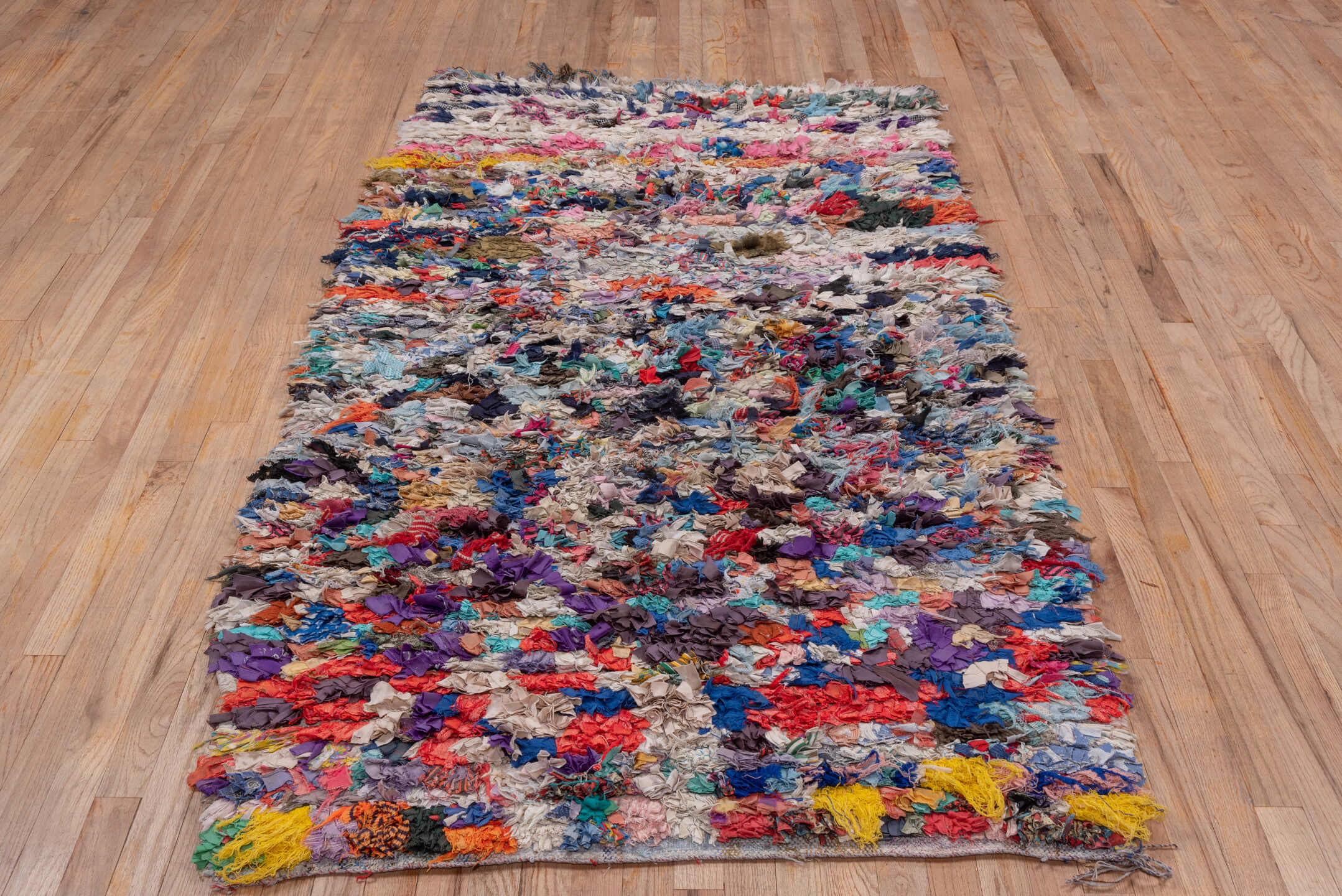 4' x 7' one-of-a-kind handmade vintage Rag Rug rug. Color palette: ivory, gray, blue, pink, purple, red, yellow, charcoal