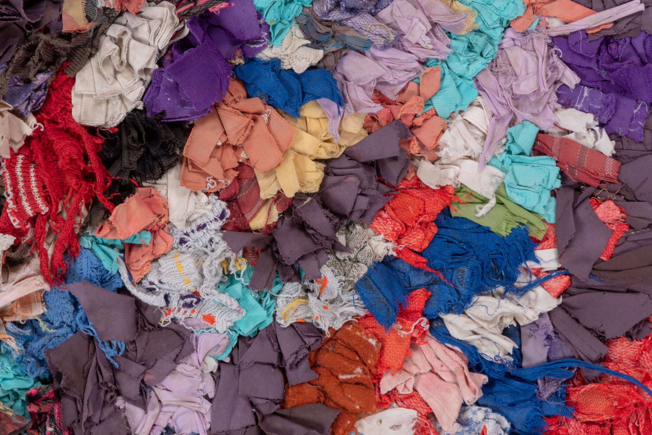 4' x 7' one-of-a-kind handmade vintage Rag Rug rug. Color palette: ivory, gray, blue, pink, purple, red, yellow, charcoal