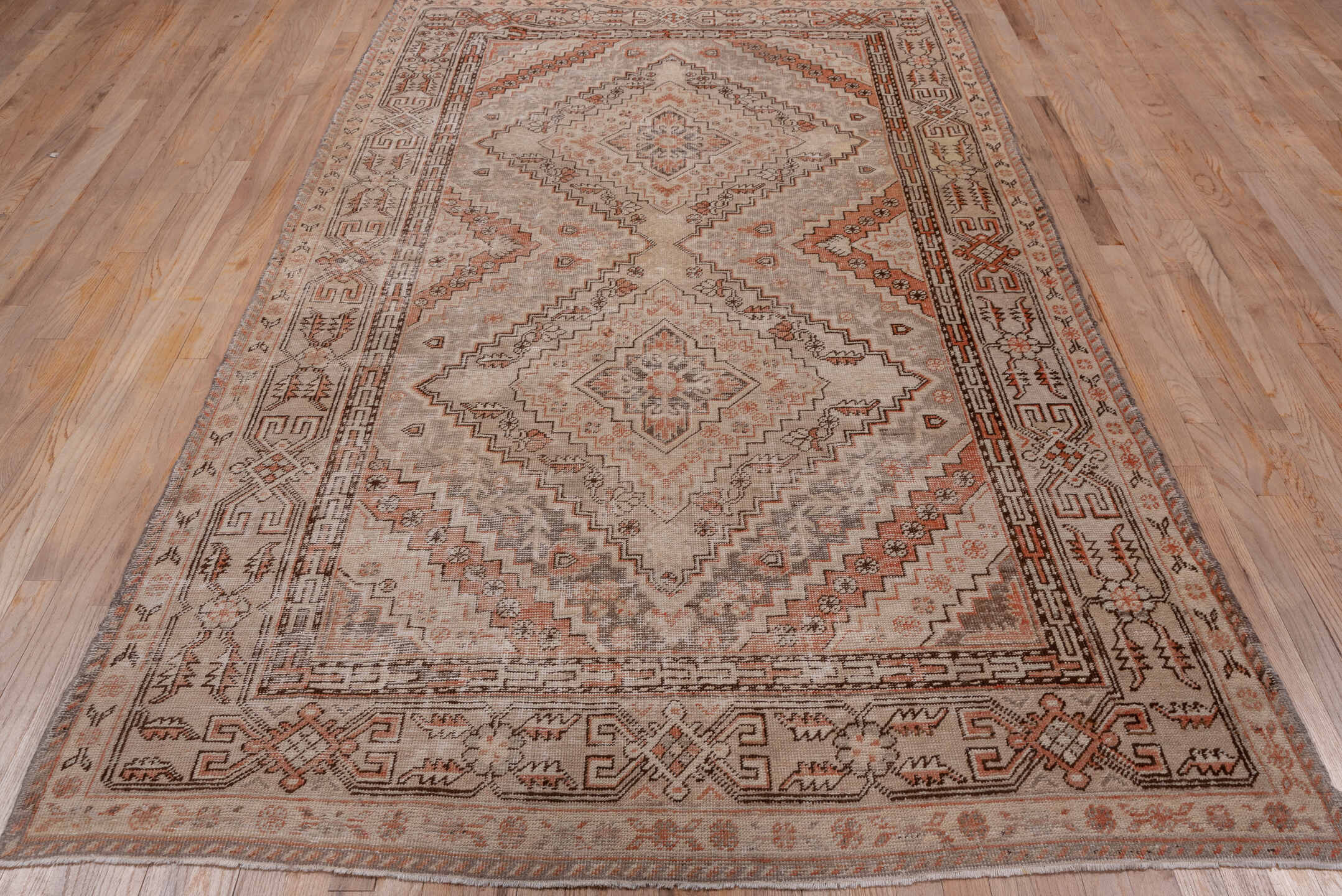 5' x 9' one-of-a-kind handmade vintage Khotan medium size rug. Color palette: brown, gray, light gray, off-white, pink