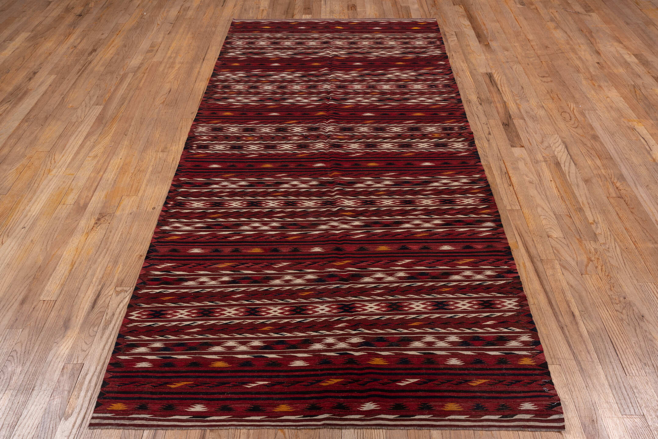 4' x 9' one-of-a-kind handmade vintage Kilim runner rug. Color palette: rust, burgundy, ivory, charcoal, gold, mahogany