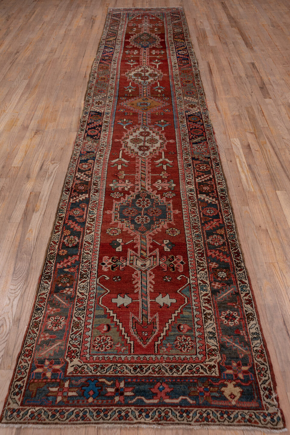 3' x 15' one-of-a-kind handmade antique Serapi runner rug. Color palette: rust, indigo, ivory, slate, rose, camel, navy