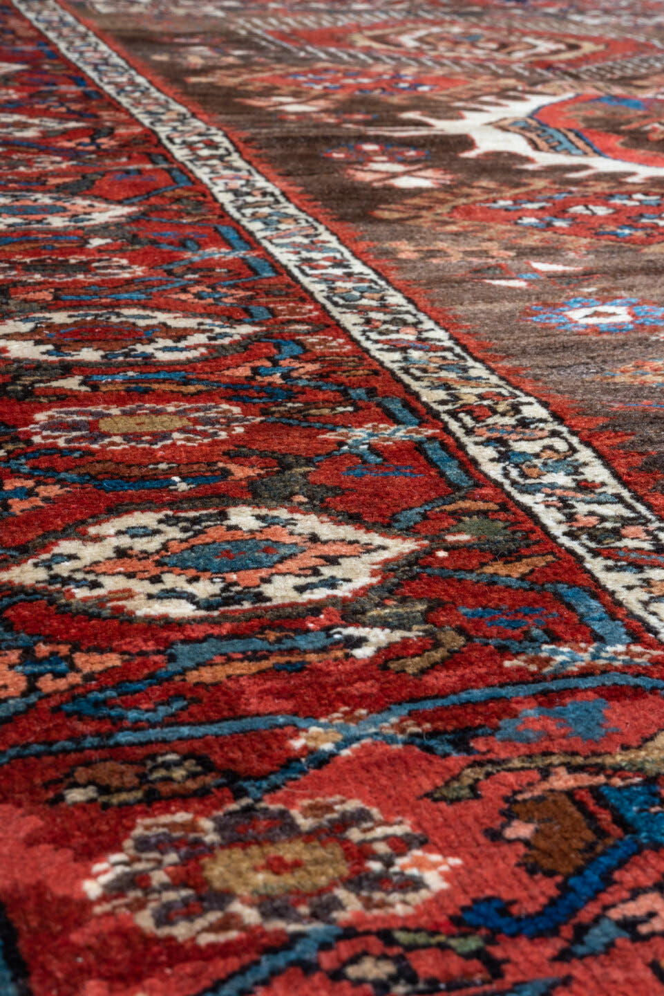 5' x 6' one-of-a-kind handmade antique Karaje rug. Color palette: rust, brown, ivory, indigo, navy, camel, crimson, taupe