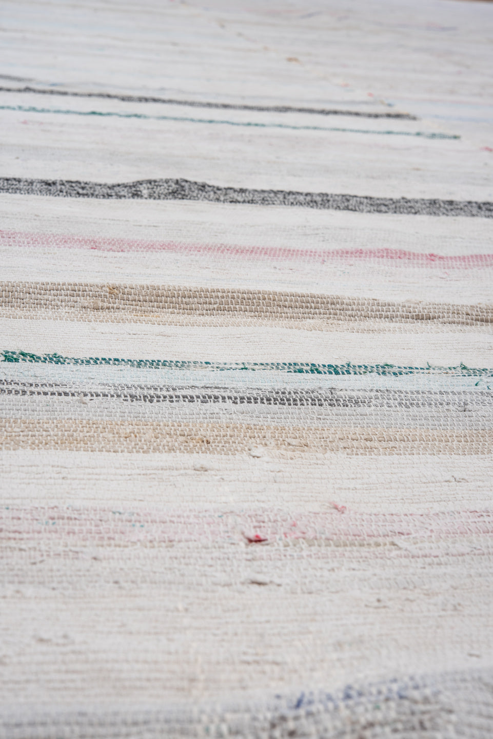 5' x 11' one-of-a-kind handmade antique Rag Rug rug. Color palette: ivory, pale blue, blush, taupe, charcoal, aqua