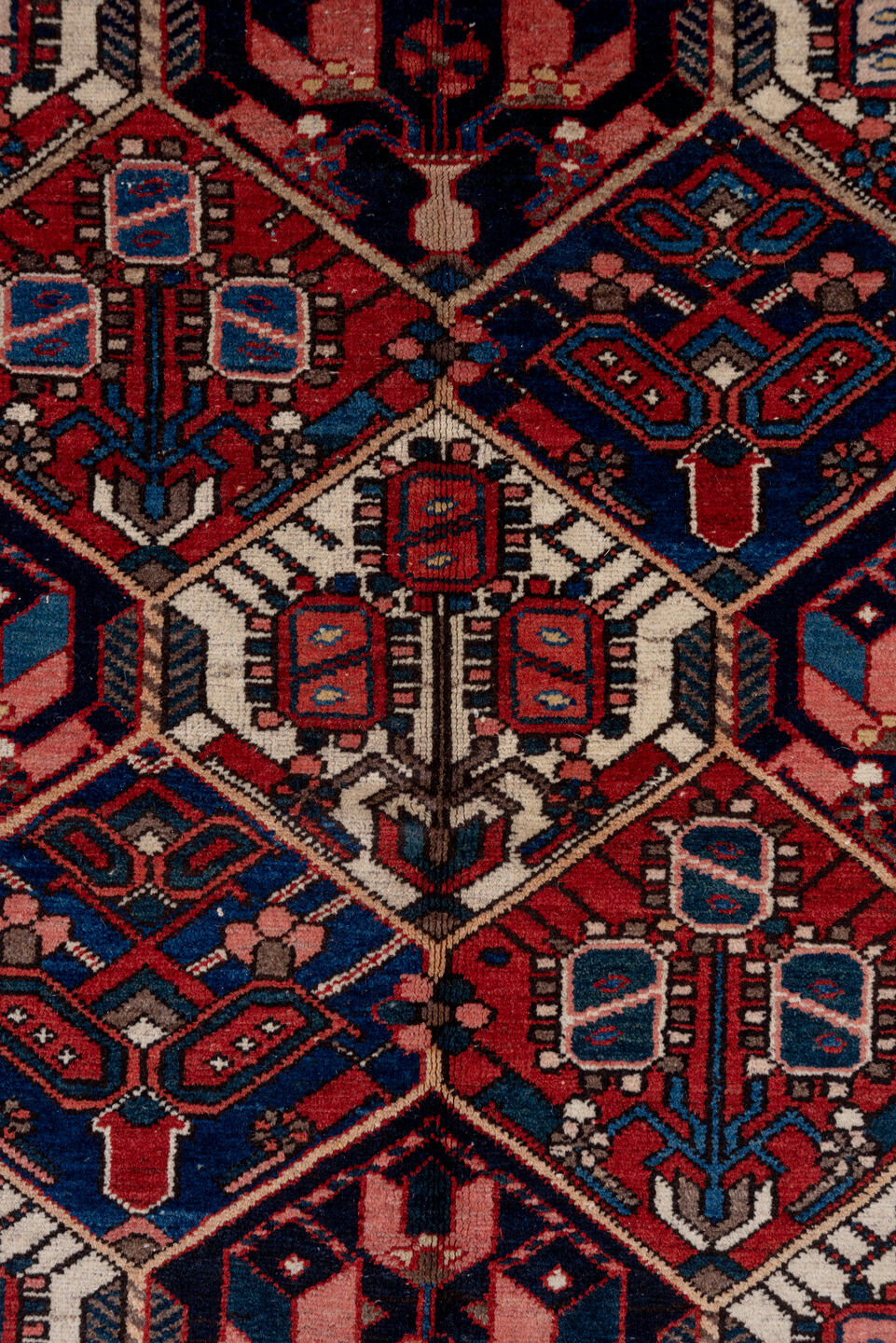 5' x 7' one-of-a-kind handmade antique Baktiary rug. Color palette: rust, ivory, navy, sky_blue, rose, charcoal, slate