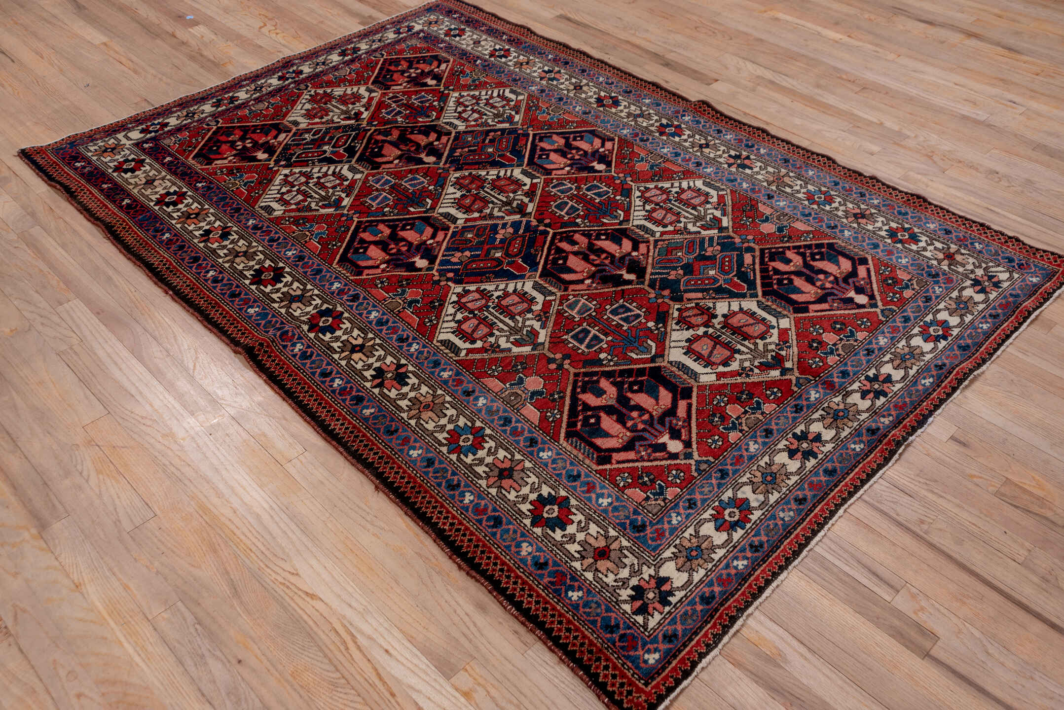 5' x 7' one-of-a-kind handmade antique Baktiary rug. Color palette: rust, ivory, navy, sky_blue, rose, charcoal, slate