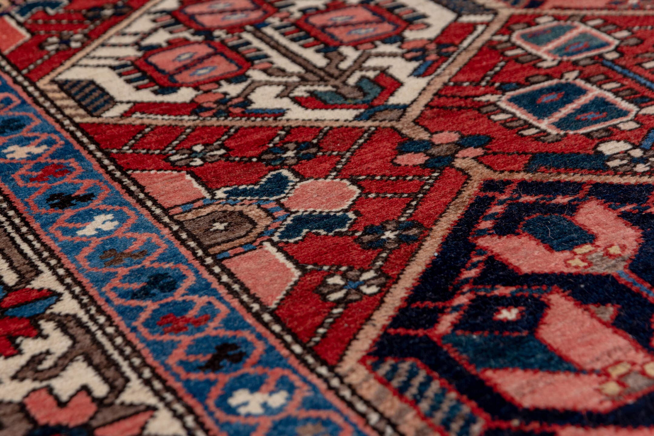5' x 7' one-of-a-kind handmade antique Baktiary rug. Color palette: rust, ivory, navy, sky_blue, rose, charcoal, slate