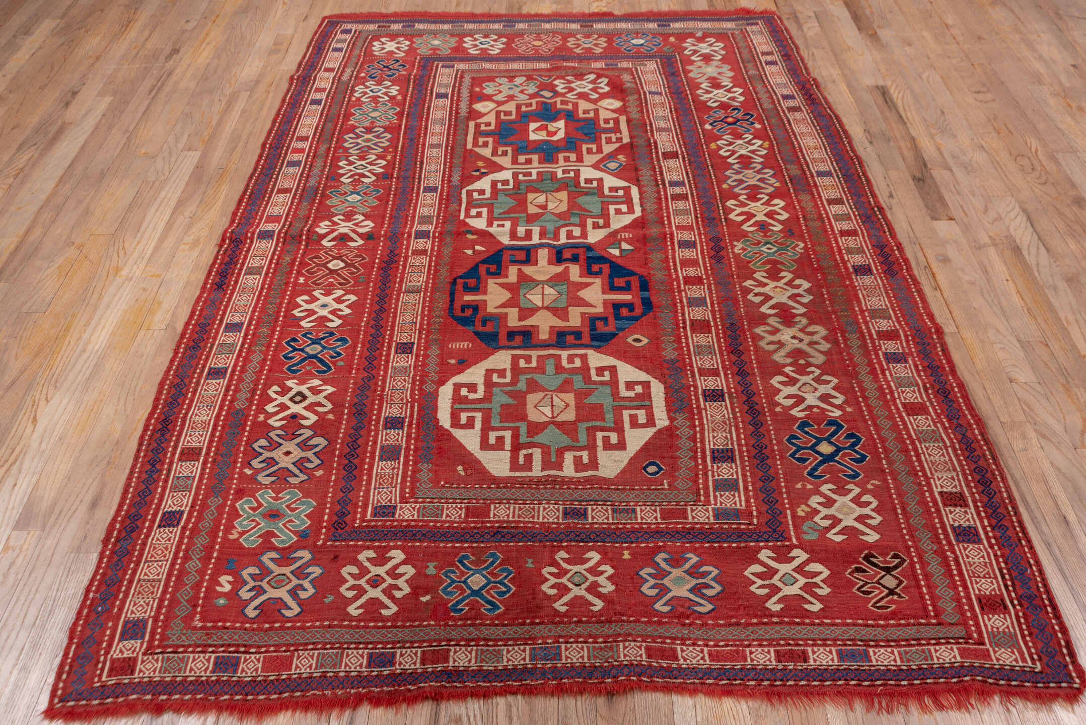 5' x 8' one-of-a-kind handmade vintage Sumak medium size rug. Color palette: blue, brown, fiord, gray, pink, red