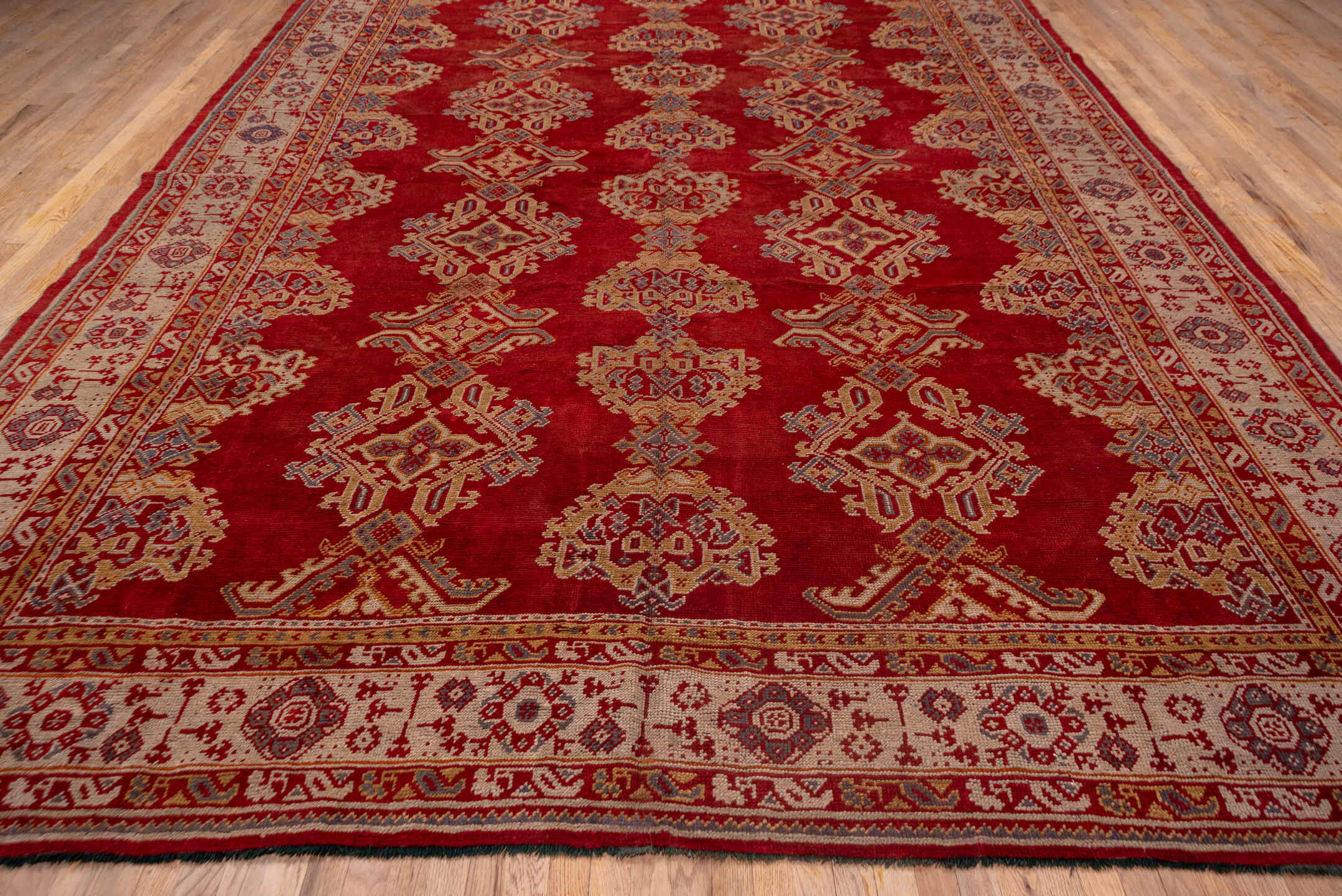 10' x 15' one-of-a-kind handmade antique Oushak rug. Color palette: rust, ivory, gold, blue, crimson, camel, terracotta