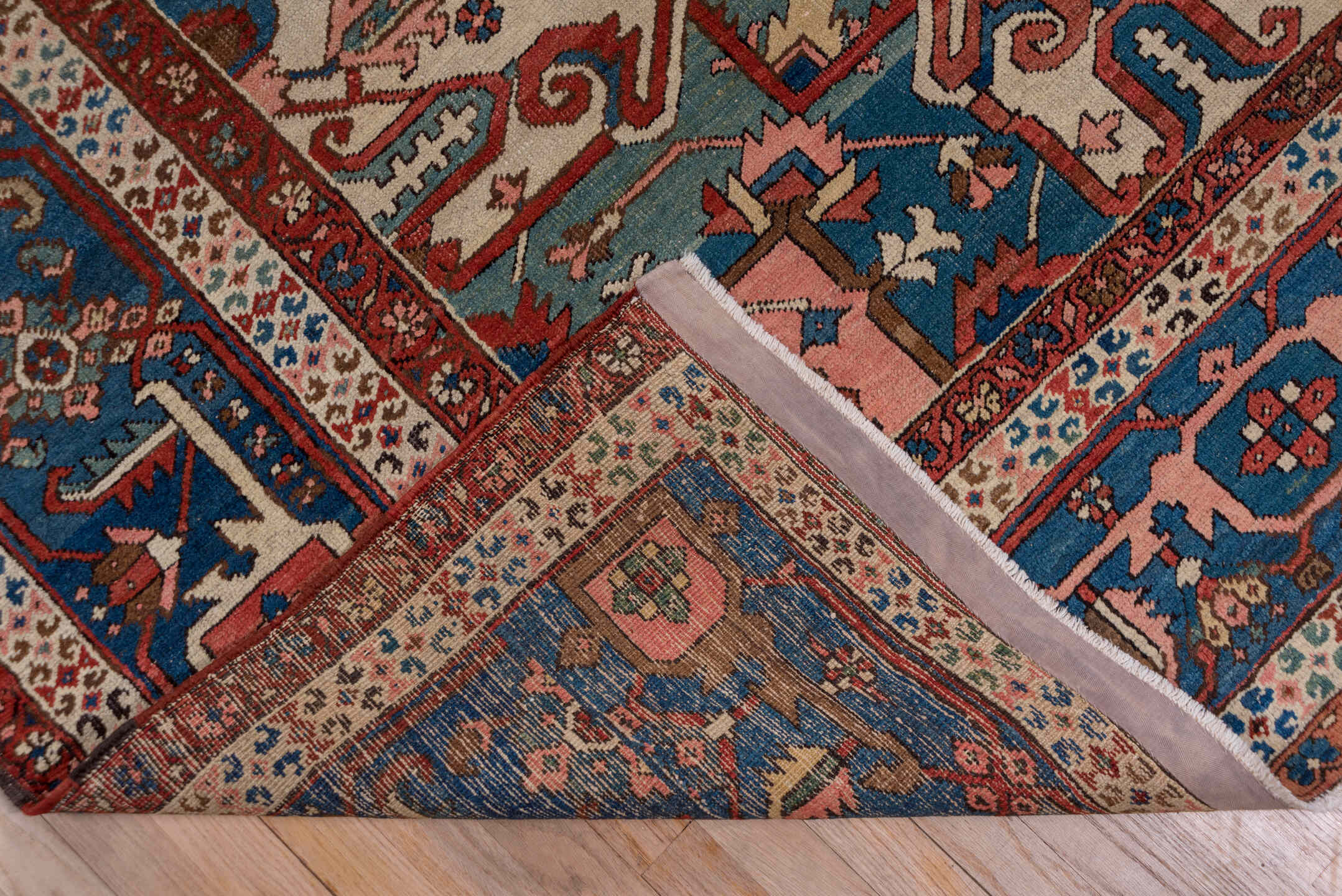 10' x 14' one-of-a-kind handmade antique Serapi large size rug. Color palette: rust, ivory, indigo, sky blue, rose, taupe